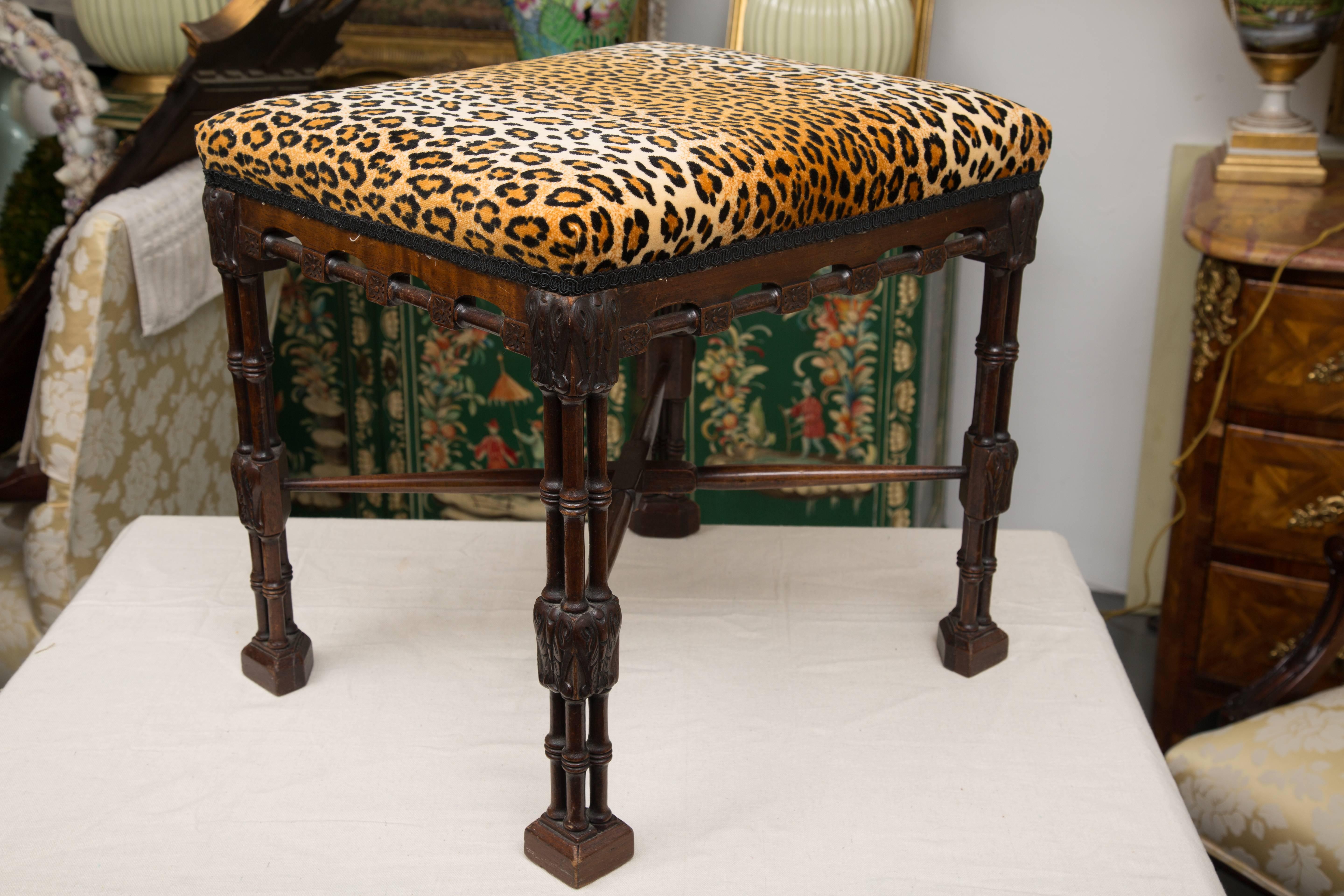 This is a striking near pair of Regency style faux bamboo benches with upholstered tops over faux bamboo friezes and supported by double faux bamboo legs ending in block feet, late 19th century.