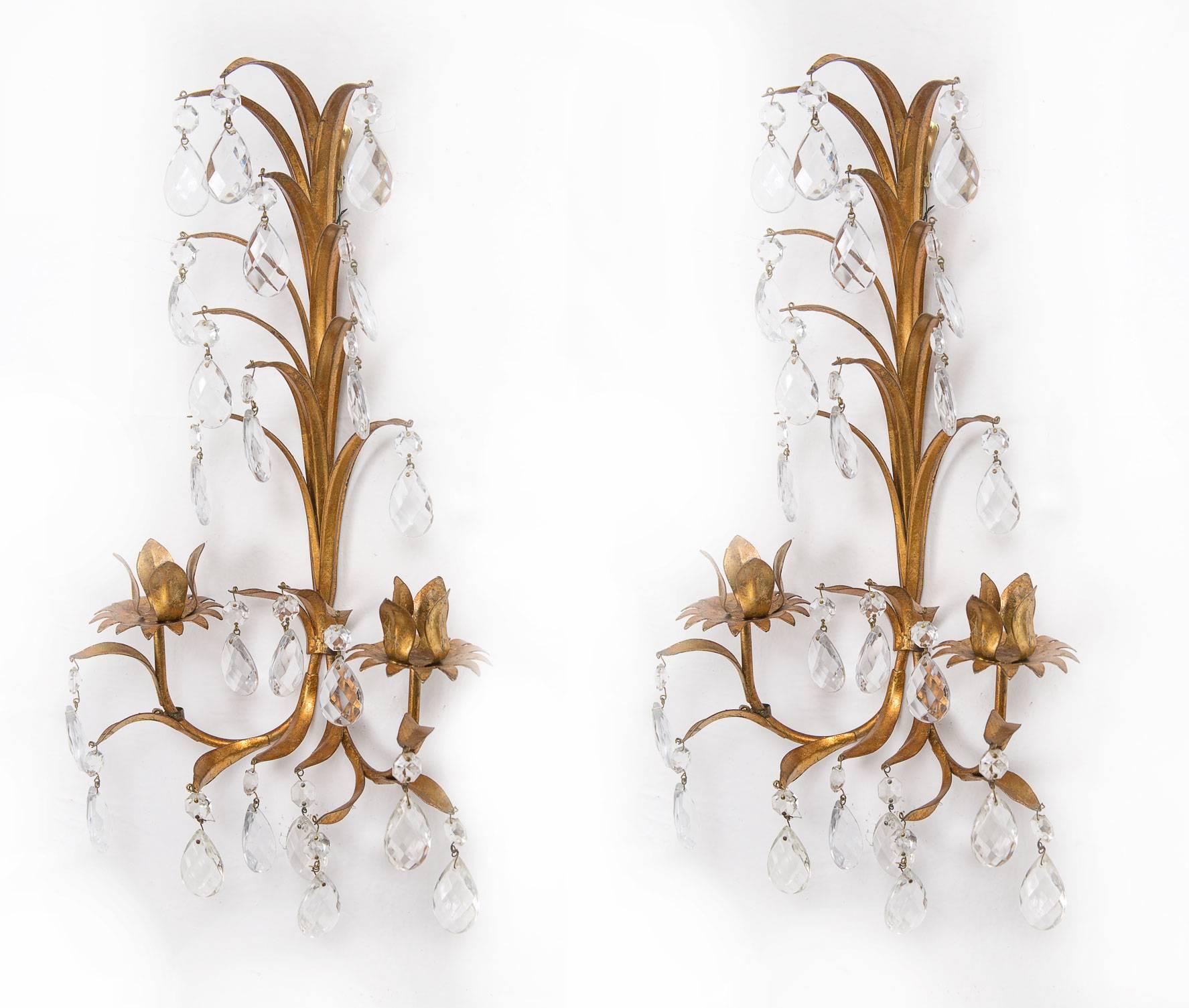 A delicate pair of Italian Florentine gilt metal sconces with faceted crystal drops and candle cups, circa 1950.
