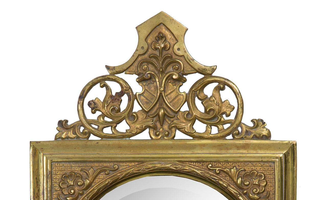 This pair of unusual American Aesthetic Movement brass sconces has a beveled mirror centered in a square frame with an ornamental cornice at the top and three candle arms emanating from the bottom, circa 1880.