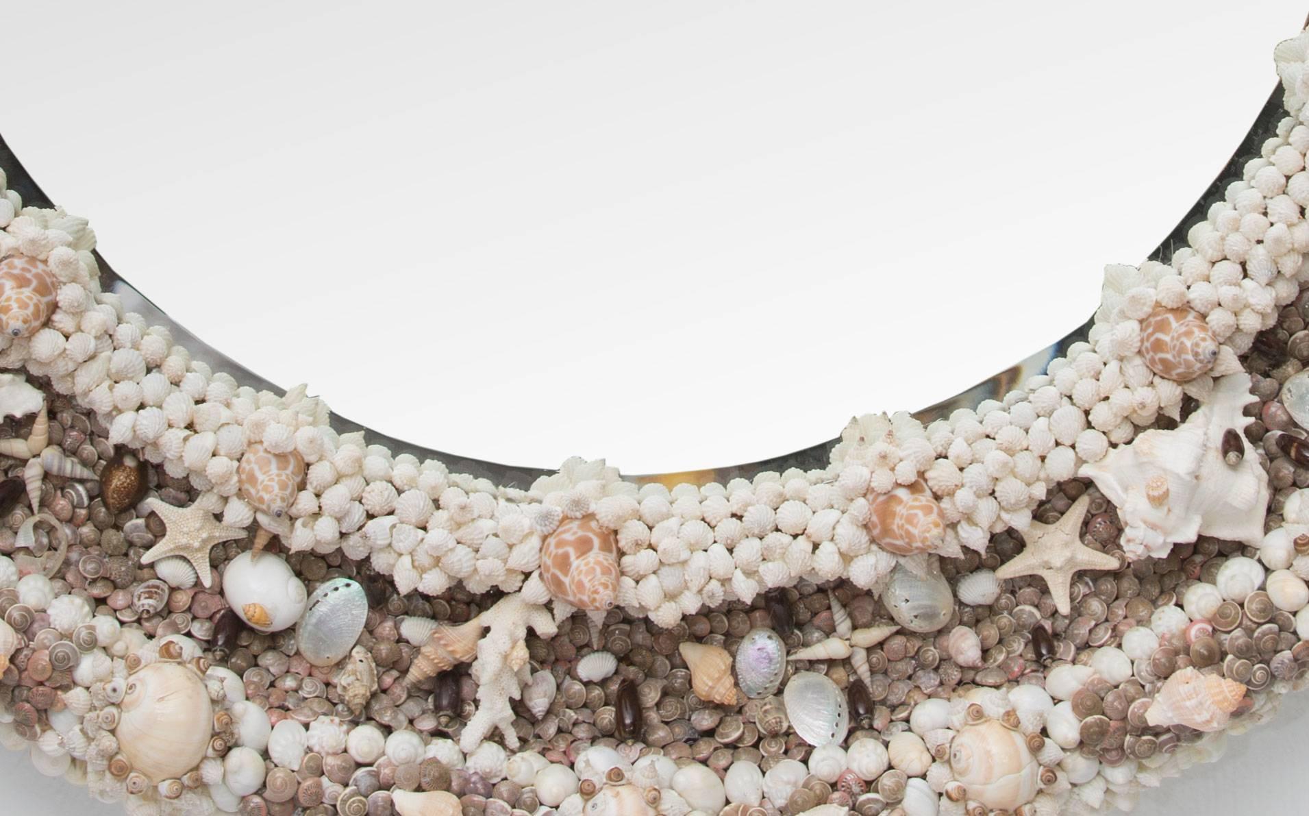 This is an impressive round mirror elaborately decorated with a variety of sea shells.