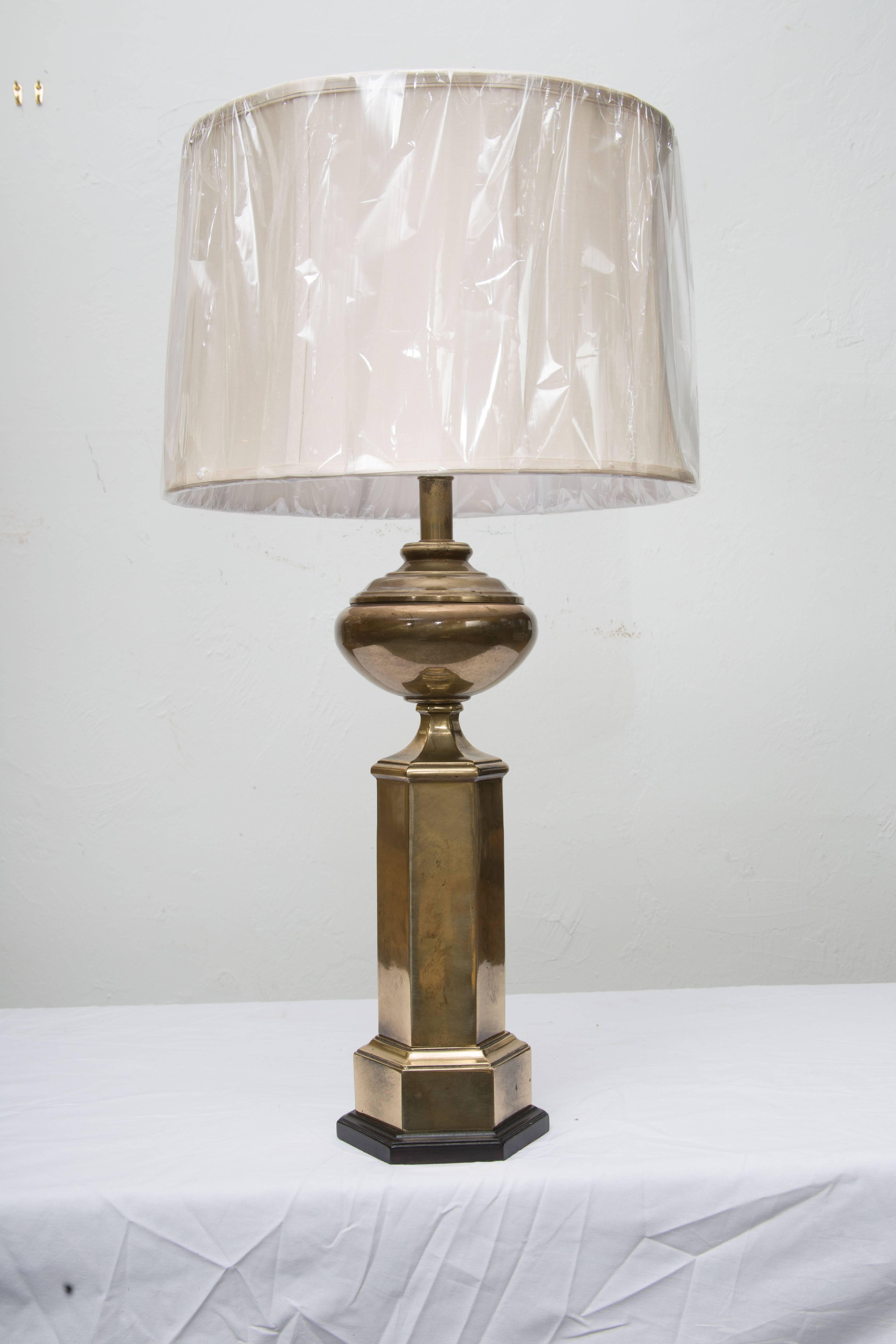 This Classic pair of hexagonal brass lamps has an antique finish and wood base offering a perfect accent for a traditional or contemporary setting. The lamps manufactured by Frederick Cooper are very high quality.