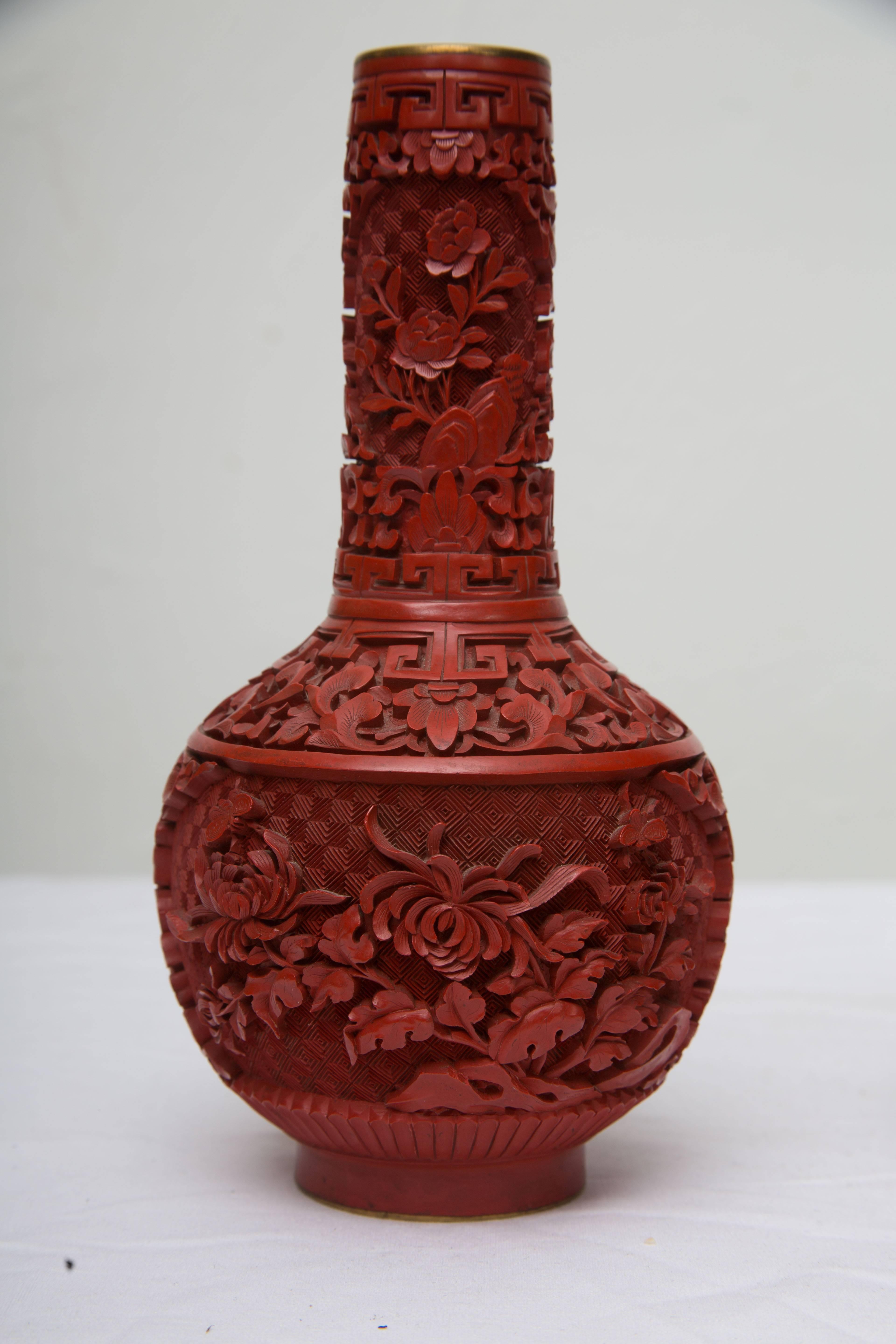 This Classic pair of vintage Chinese cinnabar bottle vases are carved with panels of birds and flowering trees, late 19th century.