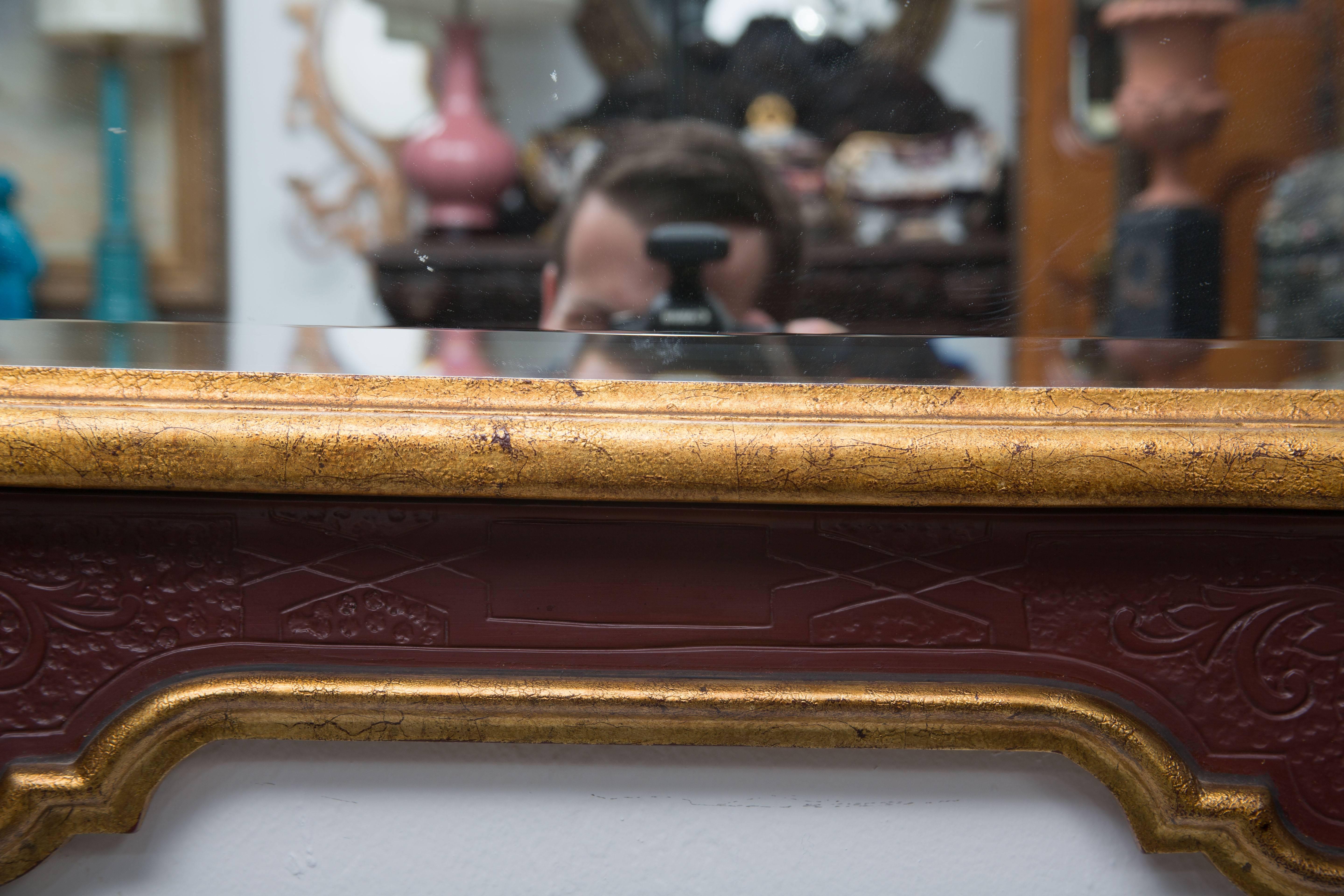 This distinctive is what masculine mirror has a cordovan-painted frame with a surface that gives the impression of tooled leather with inside and outside giltwood borders surrounding a belveled plate, circa late 20th century.