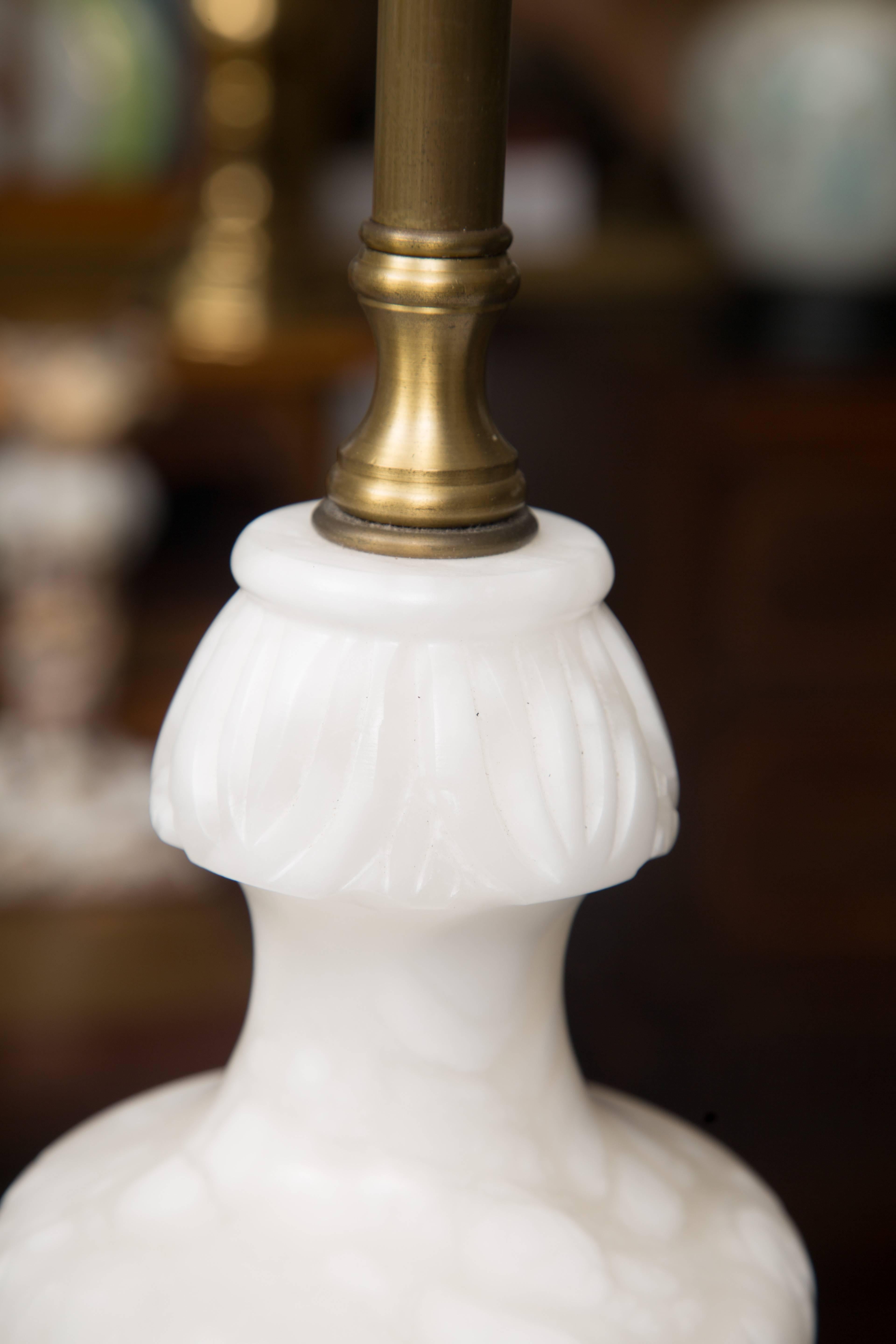 This Classic pair of white marble table lamps is situated on square brass bases and electrified with double brass sockets, circa 20th century.