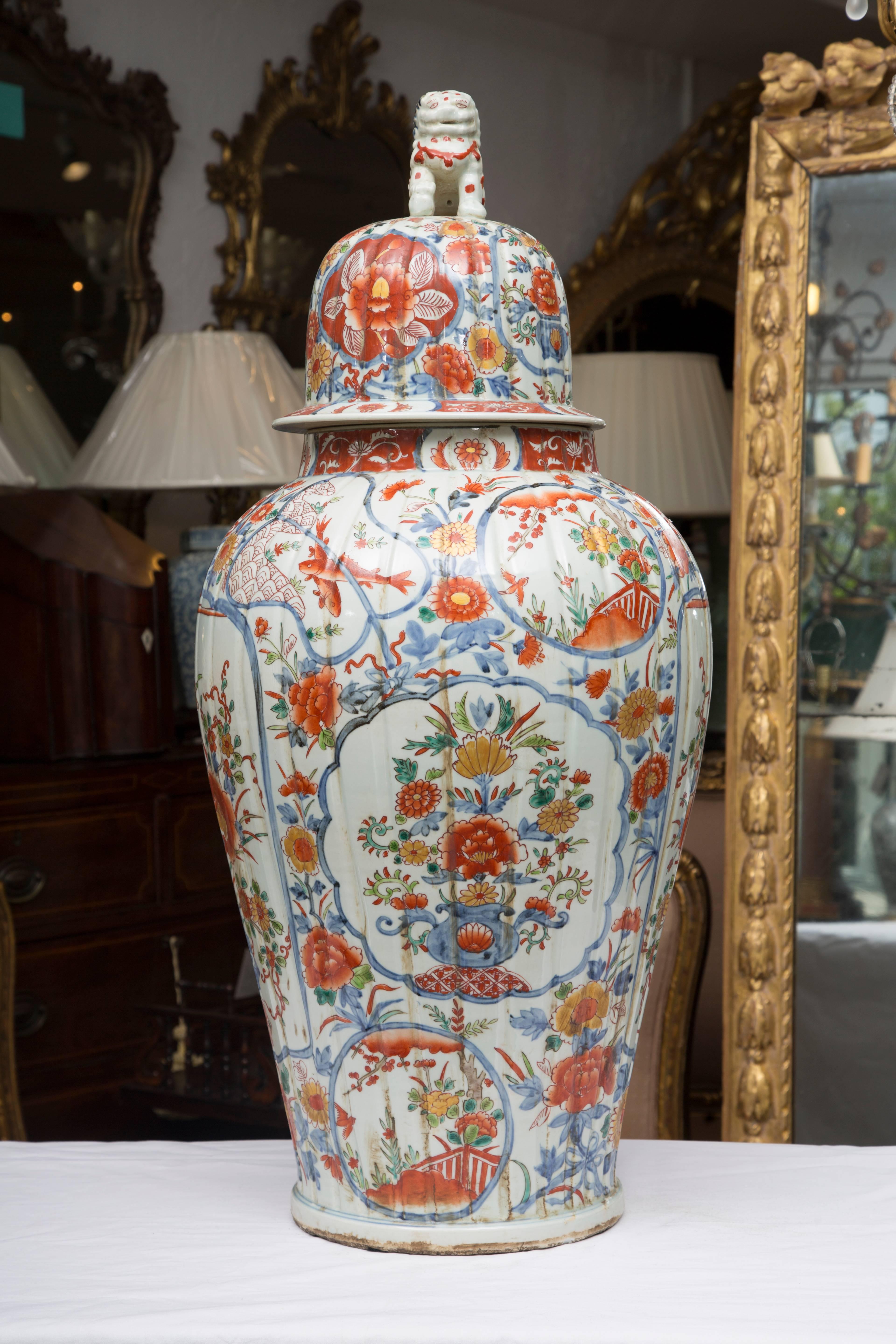 These magnificent Chinese palace lidded urns offer a soft palette of blues and bittersweet floral sprays and other naturalistic decoration. The design incorporates floral sprays within various medallion shapes . The urns are flutted and lidded with