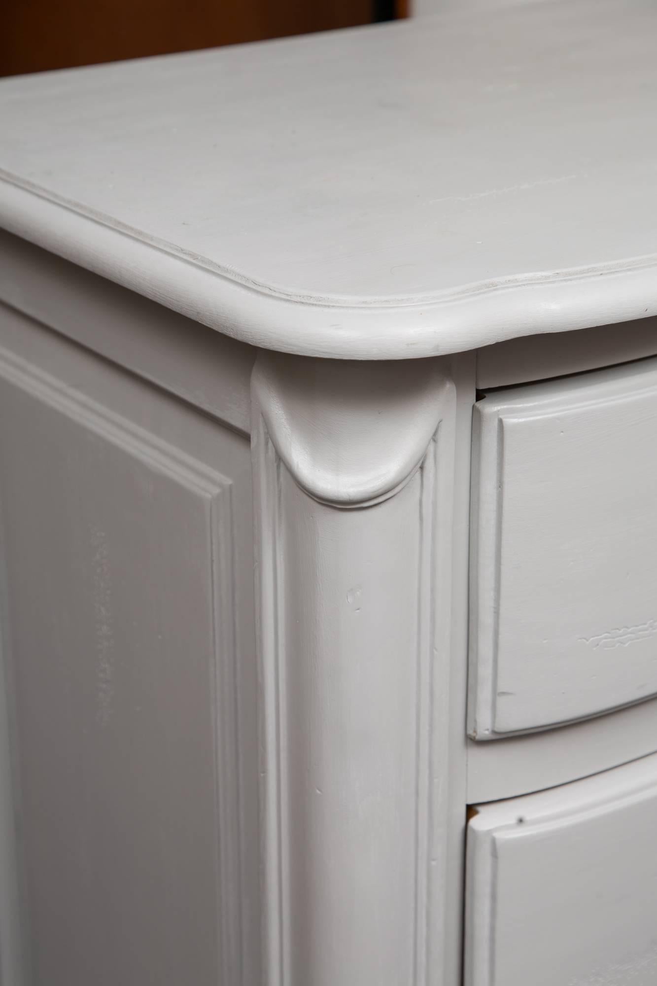 The soft grey block front three drawer chest offers a delicate accent for any room. Primary wood is pine and later painted. Hardware is highlighted in silver, circa 20th century.