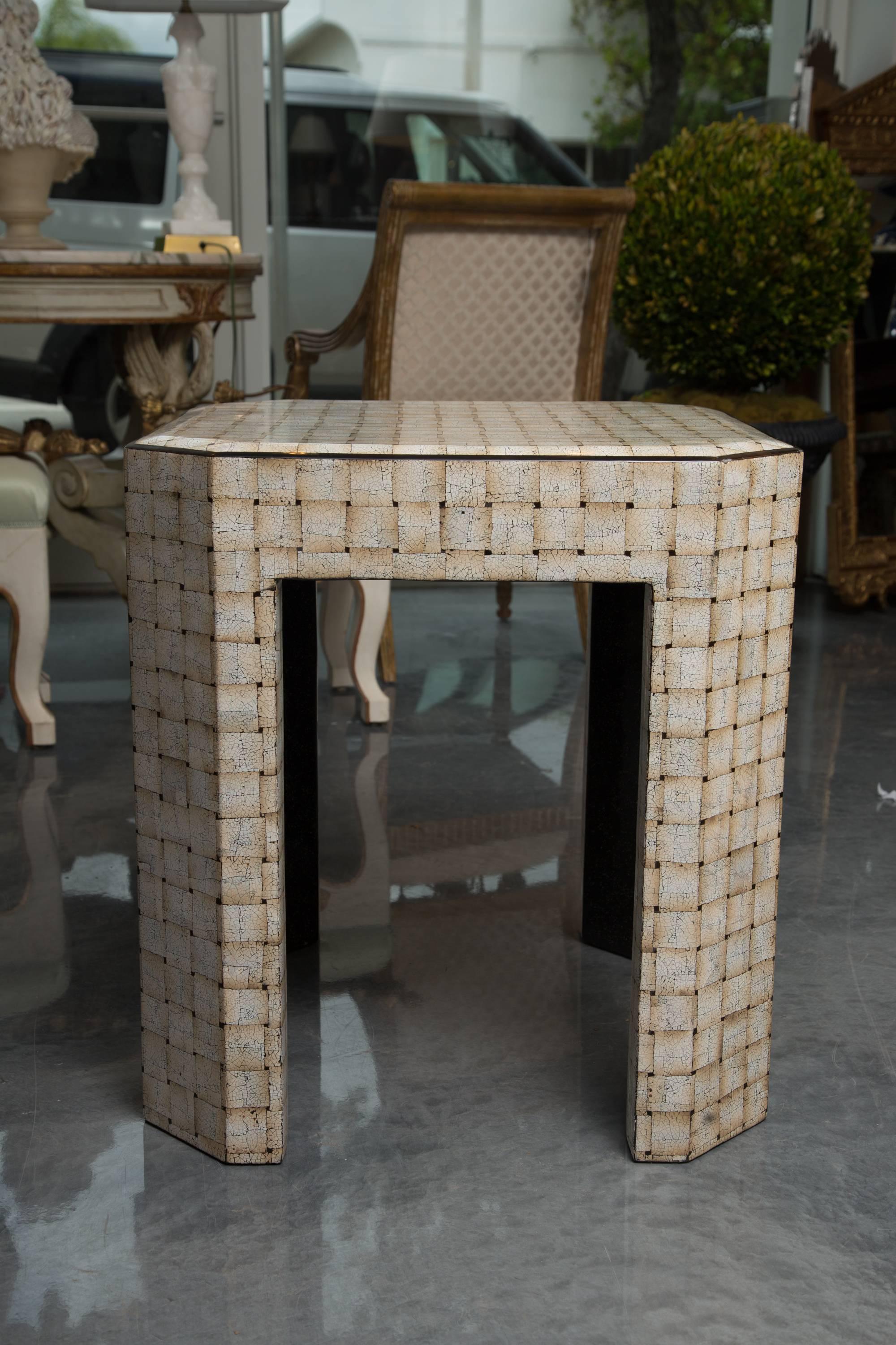 This is a very unique contemporary square table with canted corners, covered by an artistic finish of simulated crushed egg shells under a lacquered surface, circa 20th century.