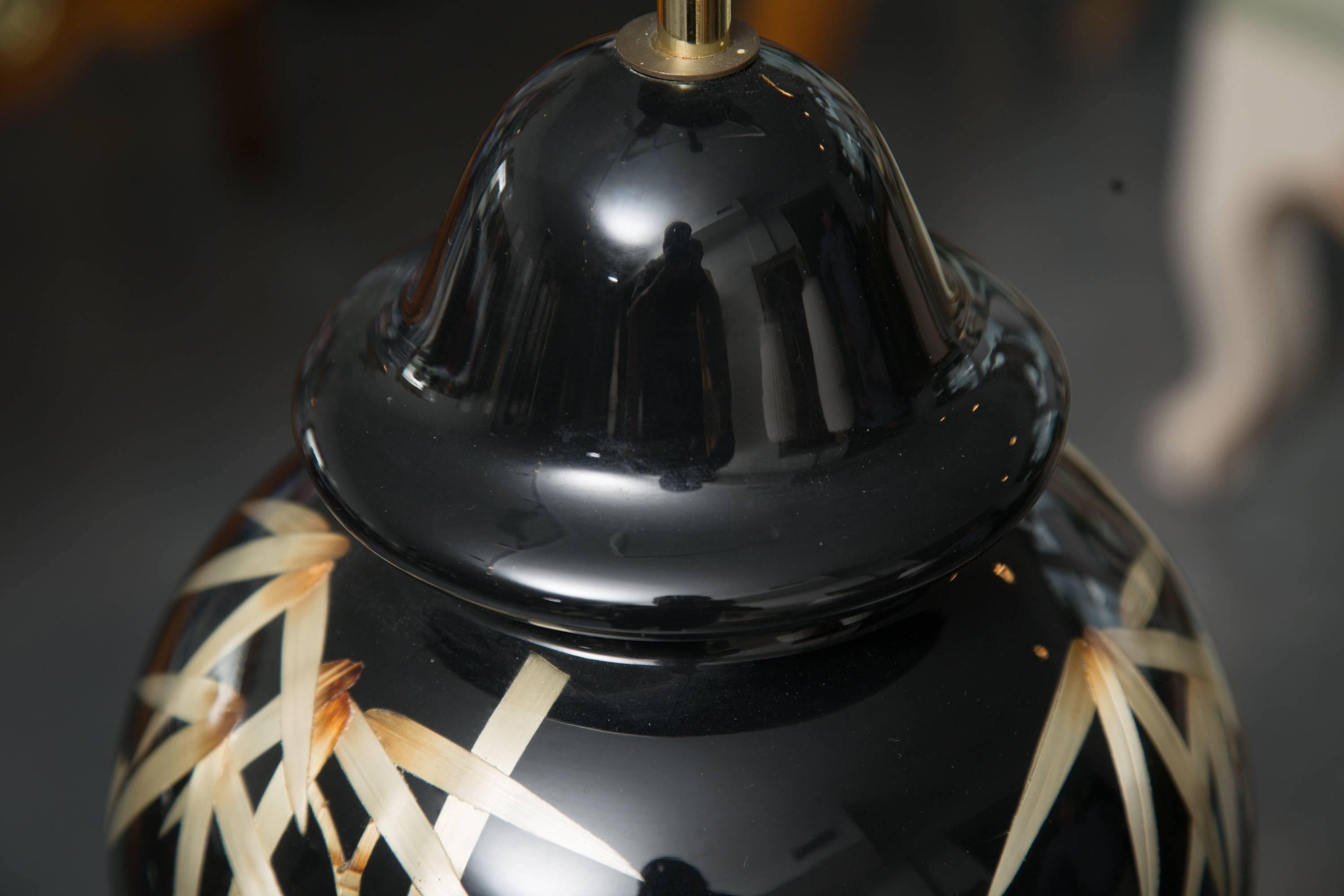 Pair of unique black lamps with natural bamboo embedded under glass, situated on wooden bases, 20th century.