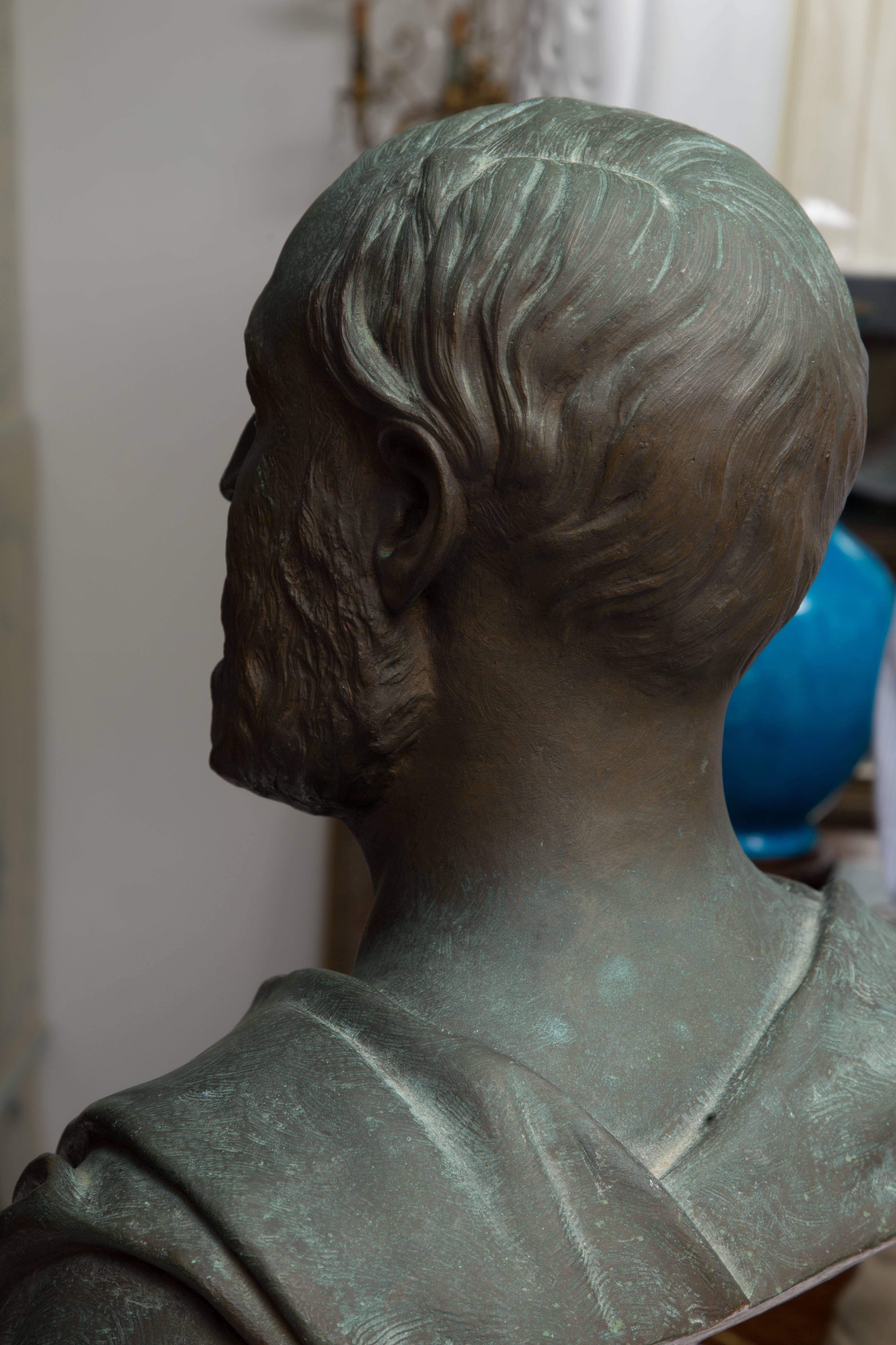 This stately patinated bronze bust is a late 19th century figure of a gentleman presented with a classical drape.