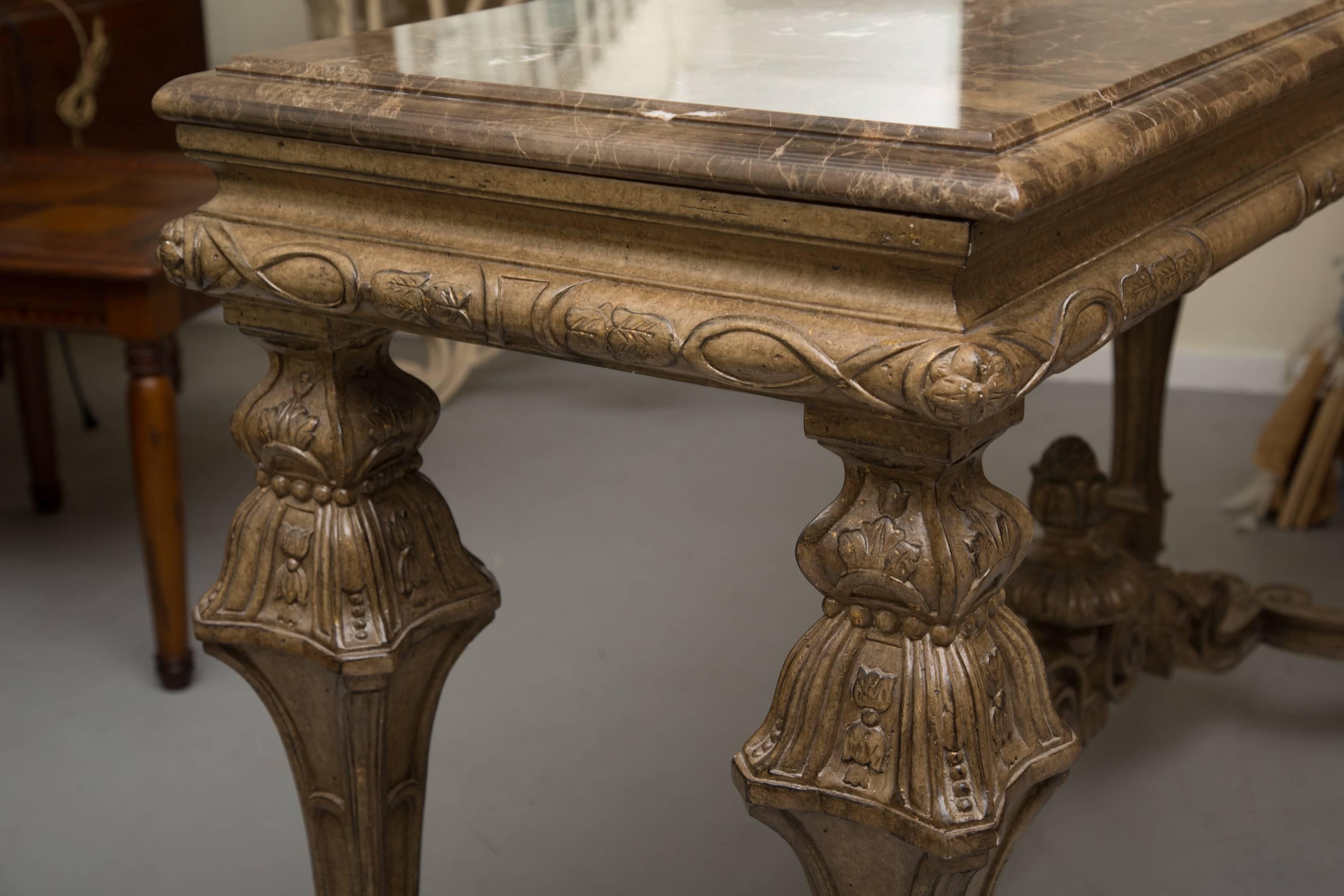 This rectangular console table can serve as a sofa table, centre table or as an impressive wall table as an anchor for any room. The marble-top rests on a deep frieze with hand-carved features typical of high style Italian Renaissance design. The