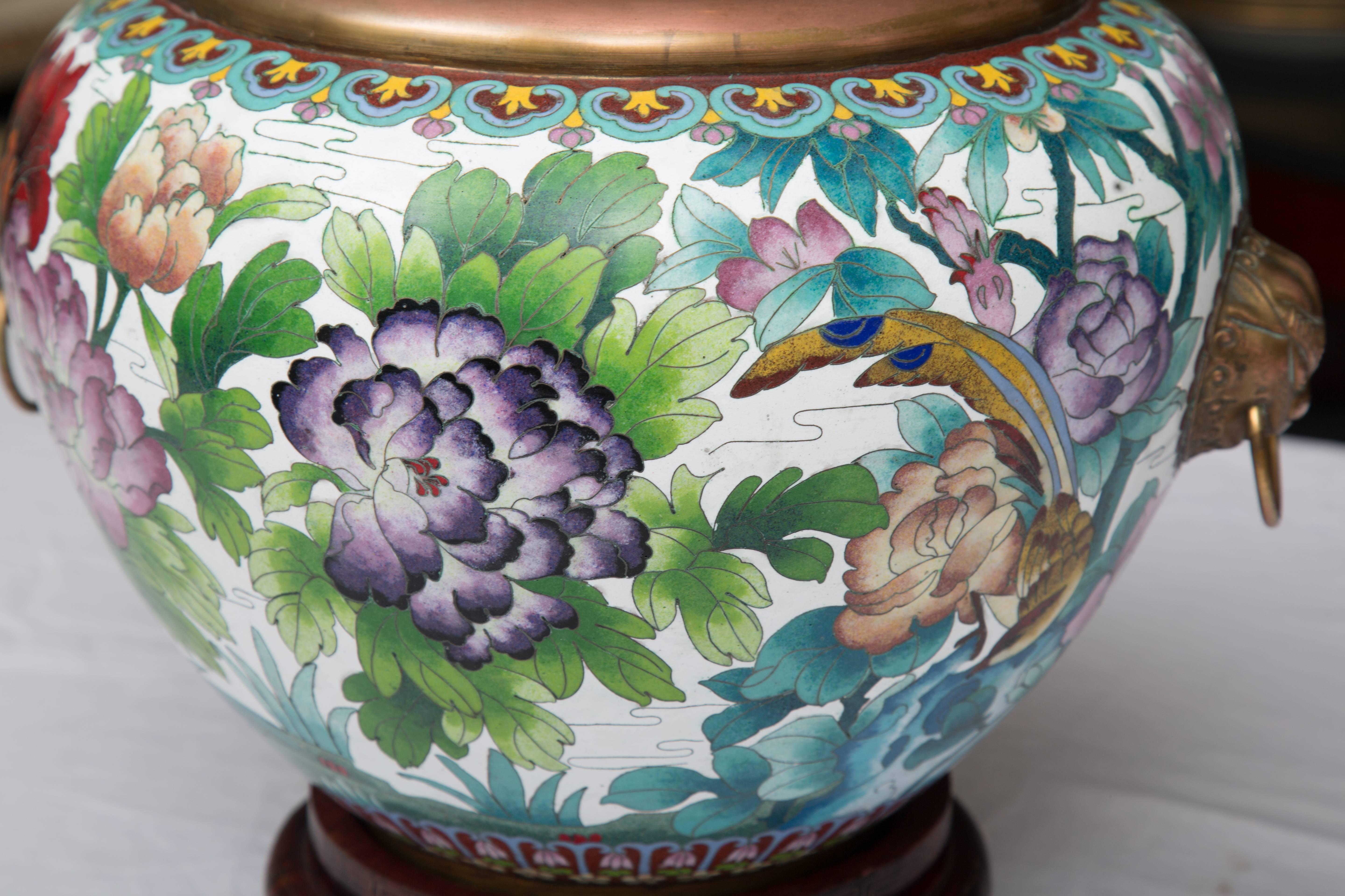 This is a colorful Chinese cloisonné jardiniere depicting birds, flowers and foliage with a prominent top rim and handles, circa 1930. 