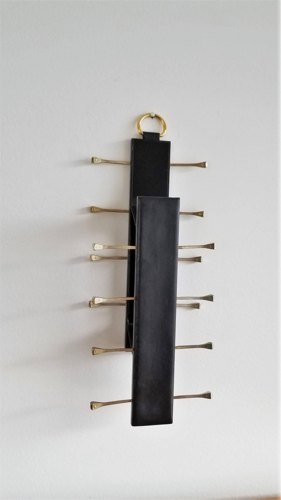 In the style of Adnet
unfolding two tiered rack
top brass hook
Measure: depth 7cm when unfolded.
 
Price does not include shipping and possible customs related charges.