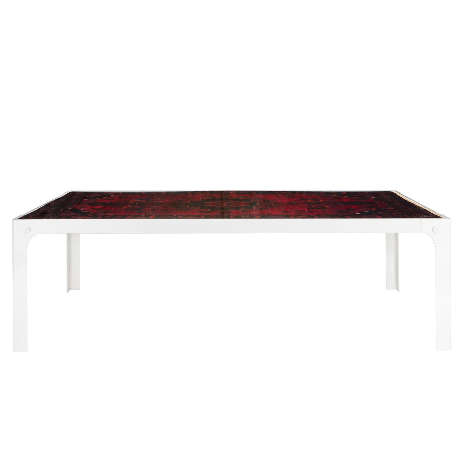 Evoking old paintings and memories of Saturday afternoons at grandma’s home, this is a modern and much more practical version of the old Dutch custom of using an oriental rug as table cover. A painted metal frame holds a true oriental rug immersed