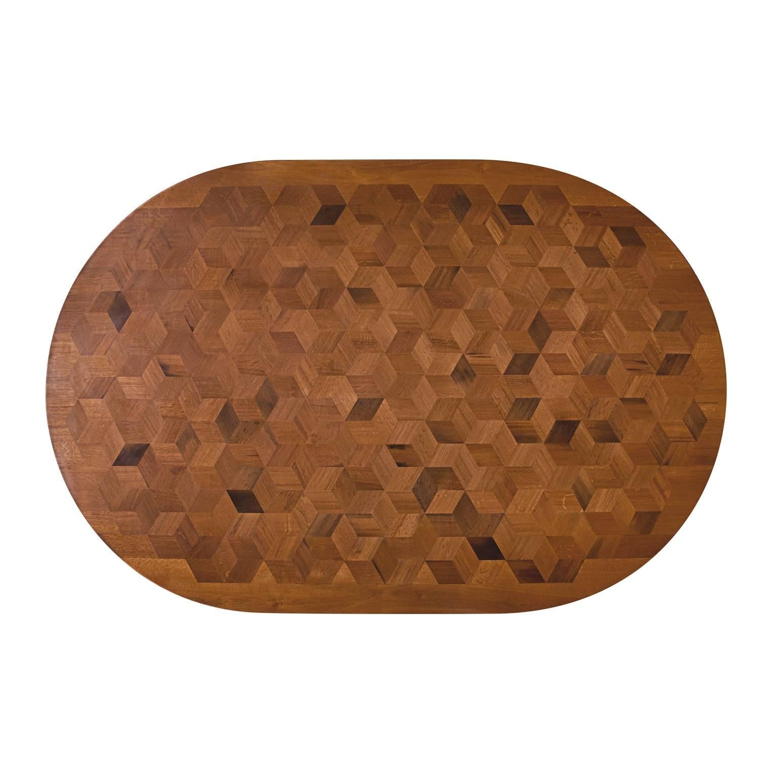 Inspired by the work of Escher, with Maurits we want to prove that a table doesn’t have to be antique to be an impressive testimony of craftsmanship. The marquetry table top in reclaimed Oak contains 381 rhombi cut from old Italian wine barrels. The