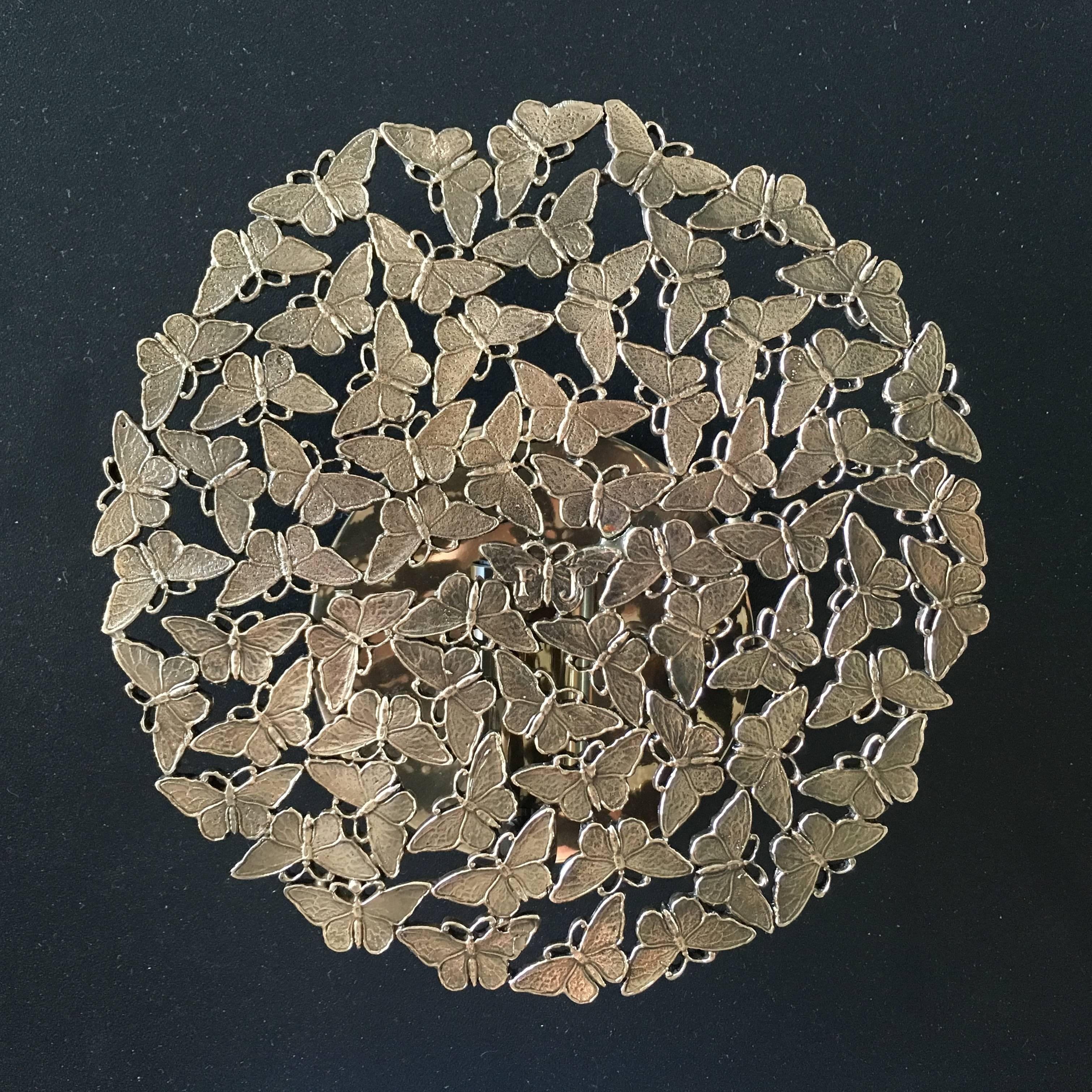 A kaleidoscope of finely handcrafted cast brass butterflies make the magic of light even more seductive combining material and ethereal in a sculptural wall sconce. Lost wax cast by master craftsmen in Tuscany, Italy.

This listing is for the bronze