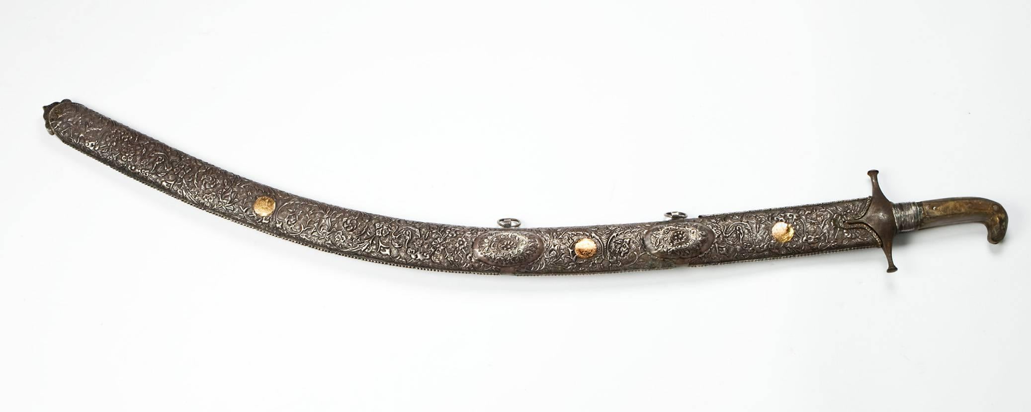 A 19th century ottoman Shamshir with watered steel blade, and scabbard made of silver and leather. It has a very special curve which is the sign its maker must have been a master of the subject.
