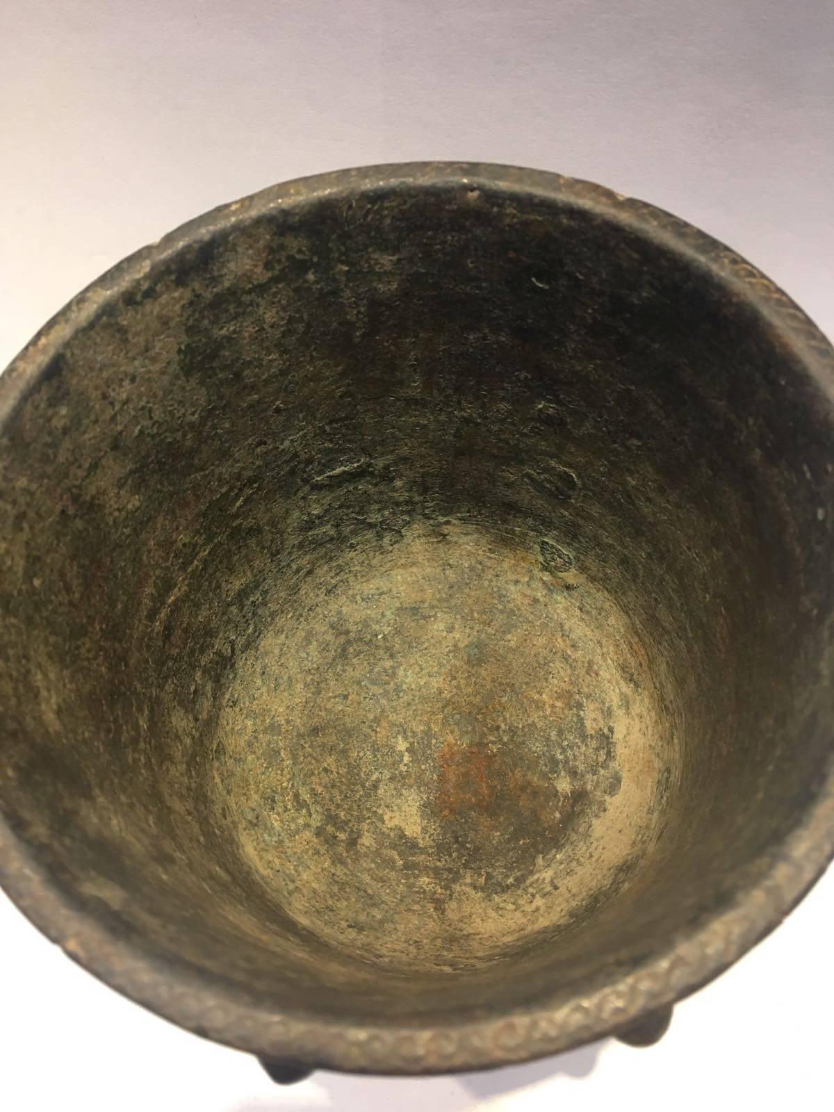12th-13th century, A Khurasan bronze mortar, Persia. The body engraved with a calligraphic band near the rim, roundels containing interlacing stellar motifs against a ground of vegetal scrolls, between a pattern of teardrop motifs raised in