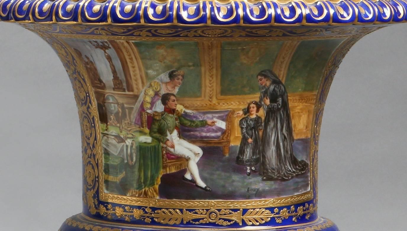 A 19th century French manufacture Impériale de Sèvres style blue urn gilt and painted with two scenes. The first painting is after a work by Frédéric Legrip entitled, ‘L'Empereur Napoléon 1er donne audience à la comtesse de Bonchamps' and