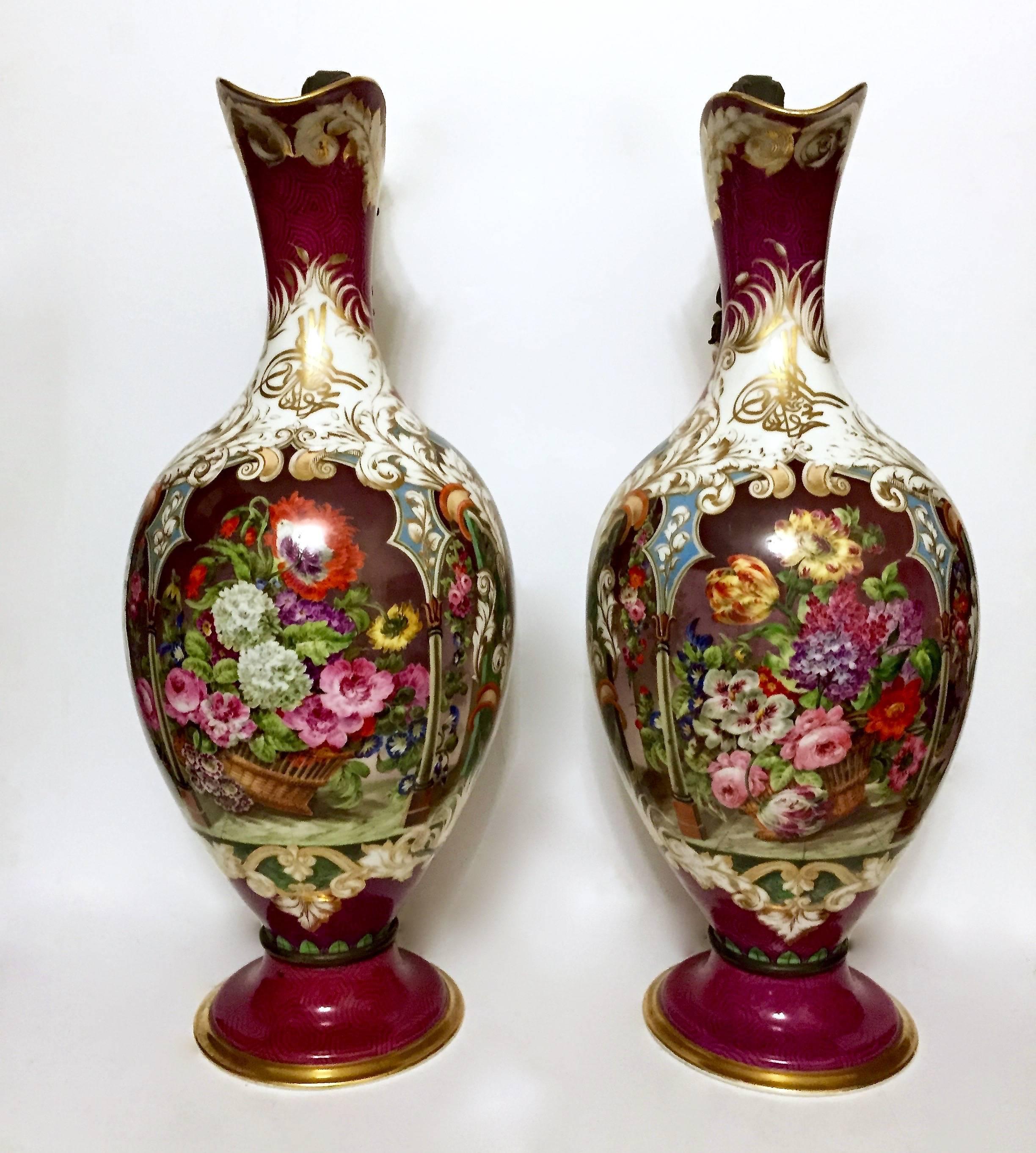 A pair of large 19th century porcelain ewers with tombac handles, featuring the tughra of Sultan Mahmud II. Each of a baluster form, with gilt tombac handles. The front of the neck features the tughra (a type of monogram/signature/seal) for the