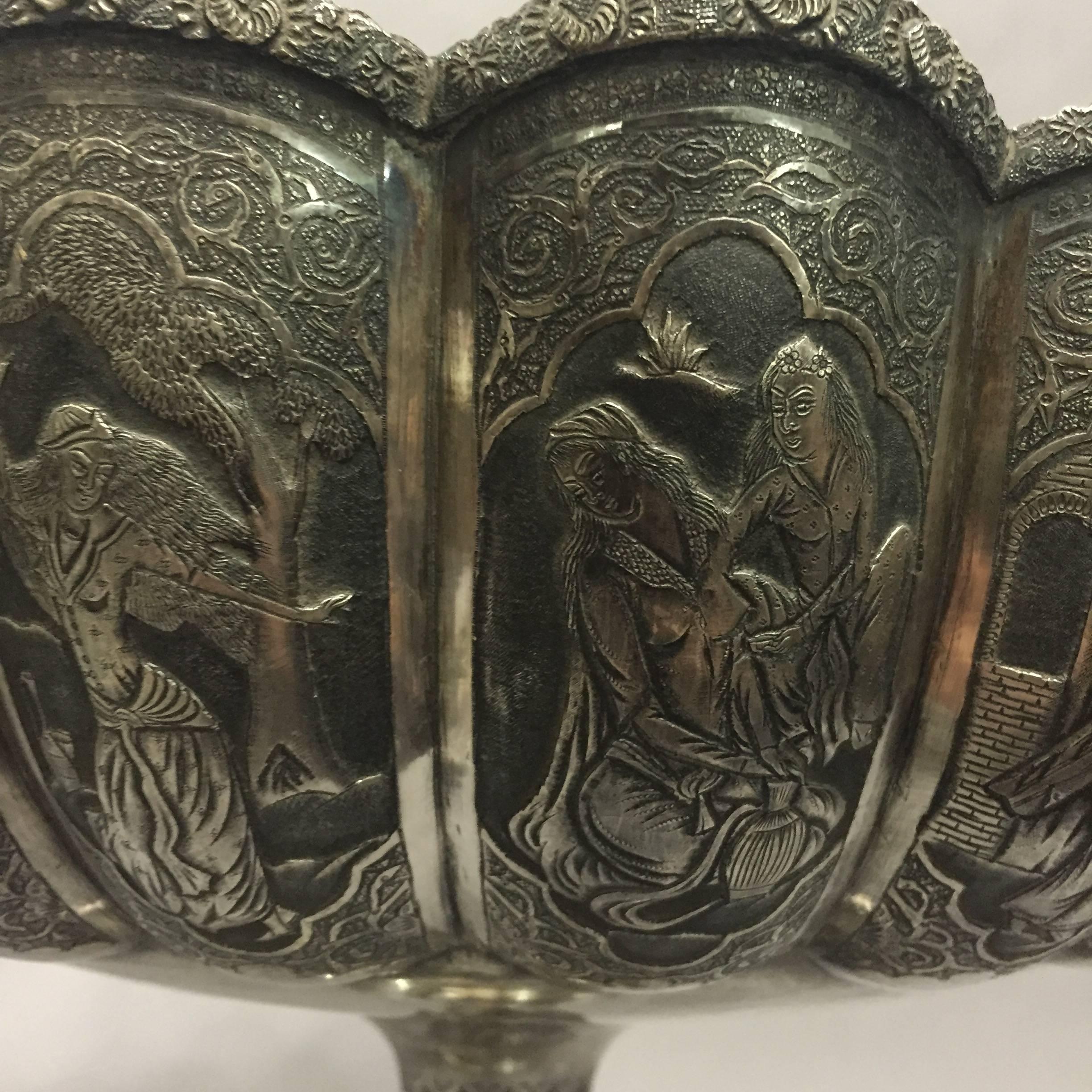 The narrative of the 'Rubbaiyat of Omar Khayyam' takes form around the top of this Isfahan silver footed basin made by Parvarish in the late 19th century. 
It is marked on the foot with the 84 silver hallmark, along with Arabic marks. Beautiful