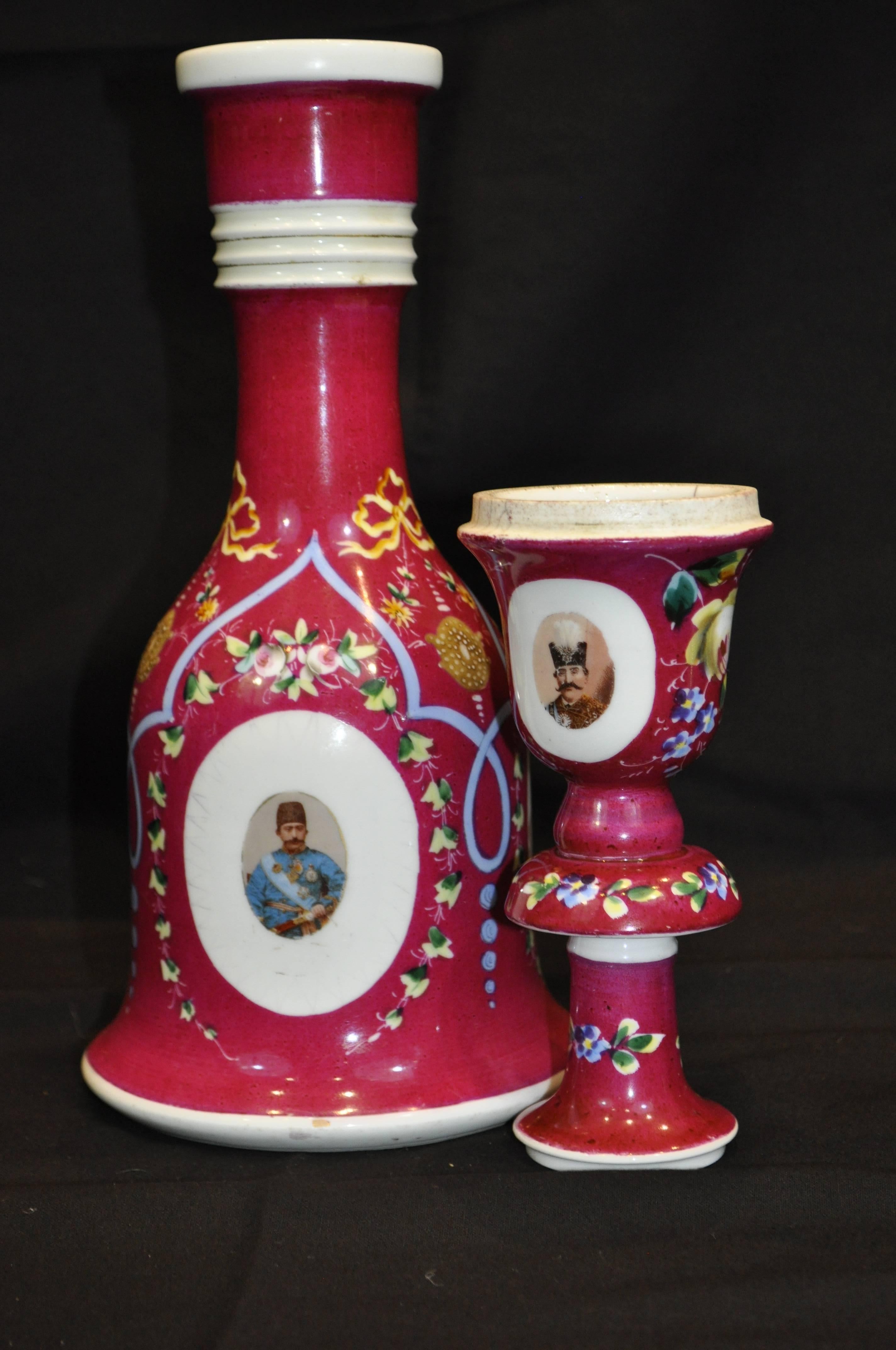 A group of five Bohemian ceramic nargileh (hookah) bases with their cups featuring medallions of Eastern Potentates.
They are decorated in colourful foliate and floral motifs. The main colours include blue, bright pink, magenta, yellow, and orange.