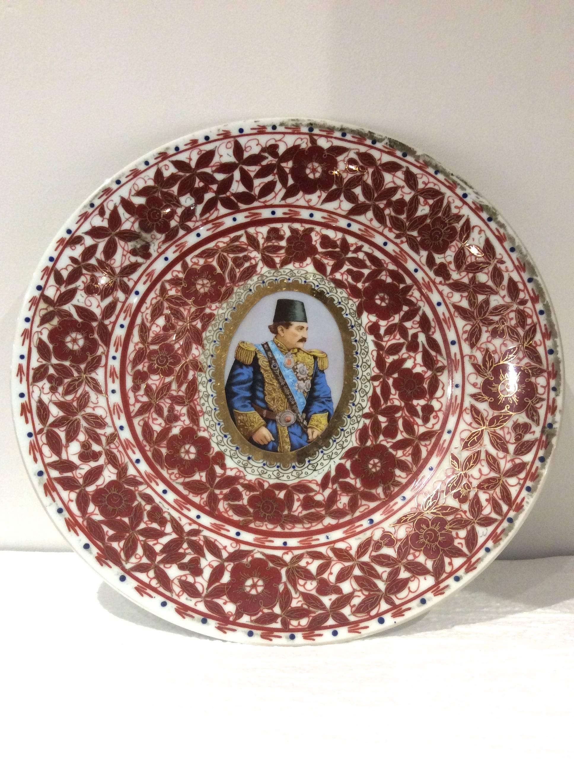 A set of six late 19th century ceramic Qajar plates featuring various Eastern Potentates. They are decorated in colorful foliate and floral motifs. The main colors include blue, red and gold. They are featuring large gilt central medallions