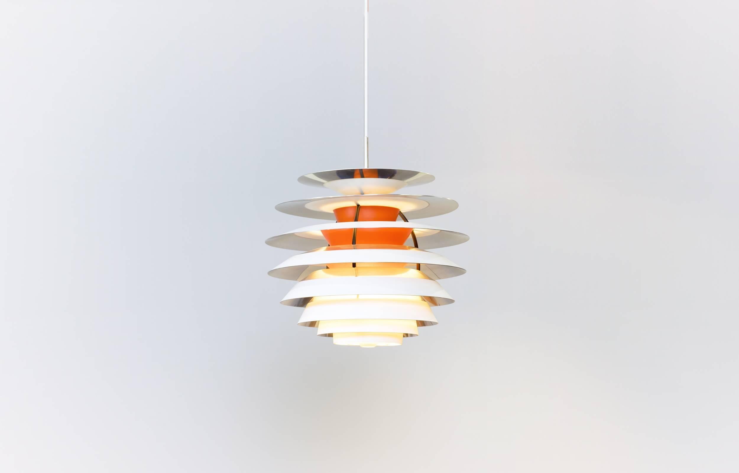 Wonderful pendant lamp. Out of production. White/orange lacquered metal and chromed parts with black laquered brass fittings. New white 2.5 m fabric cord.

Perfect original condition with minor wear consistent with age and use.