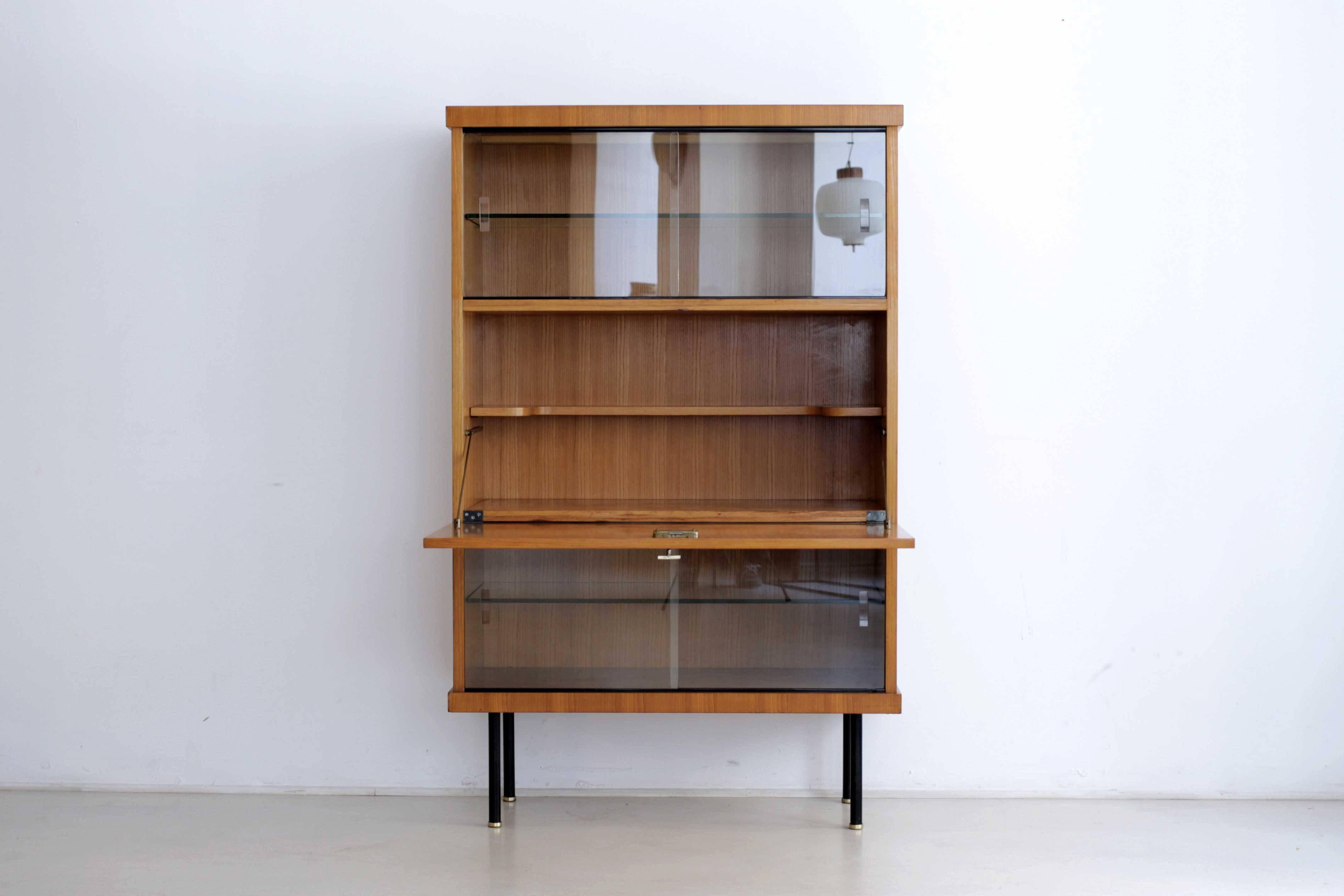 Bar cabinet, from the Monaco series, made out of elmwood veneering, which includes sliding glass doors and a unit bar in the middle. It was made in France by Magnani.