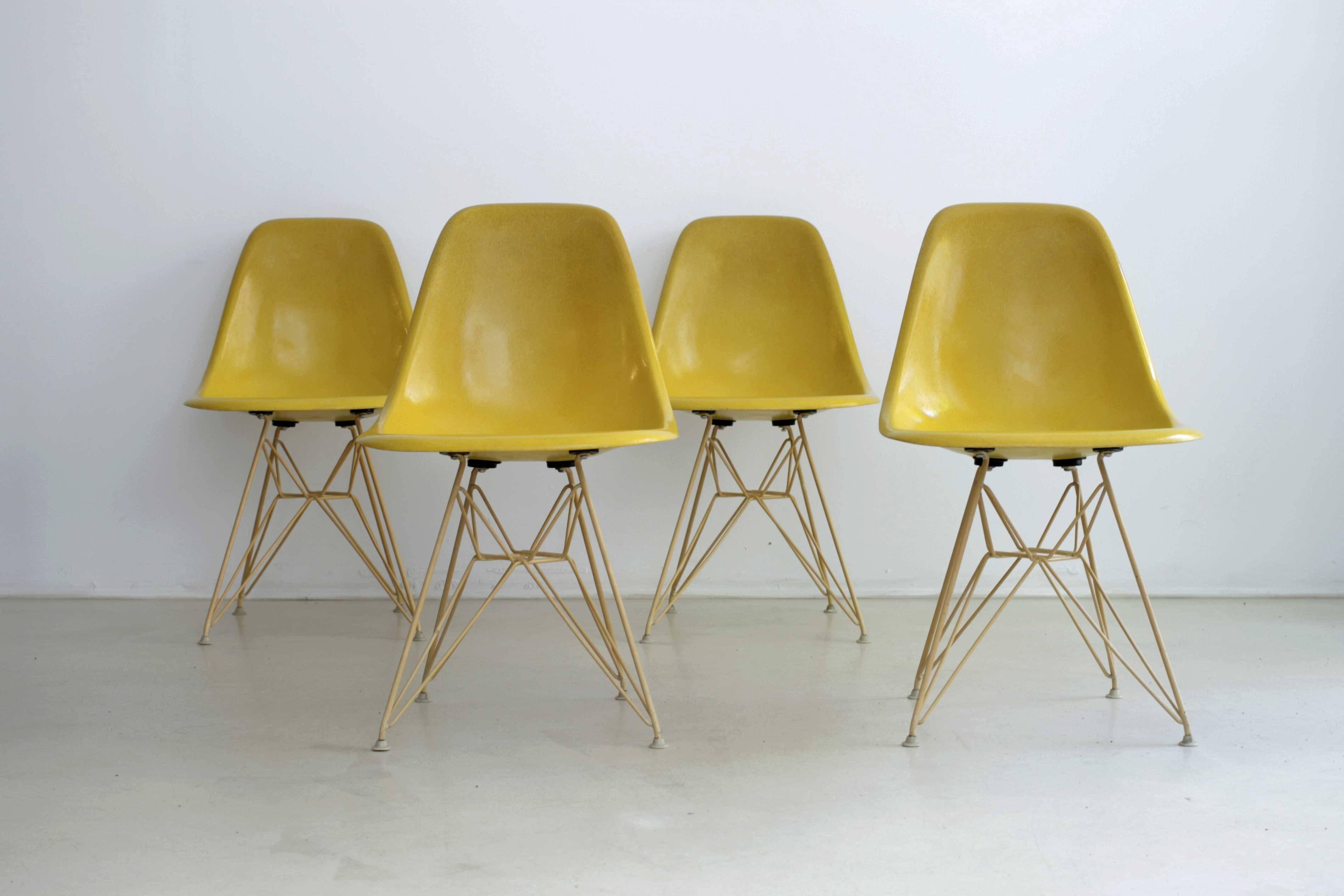 Rare set of four Eiffel tower base chairs made by Herman Miller. Original bases covered with a Rislan. Chairs are in very good condition.