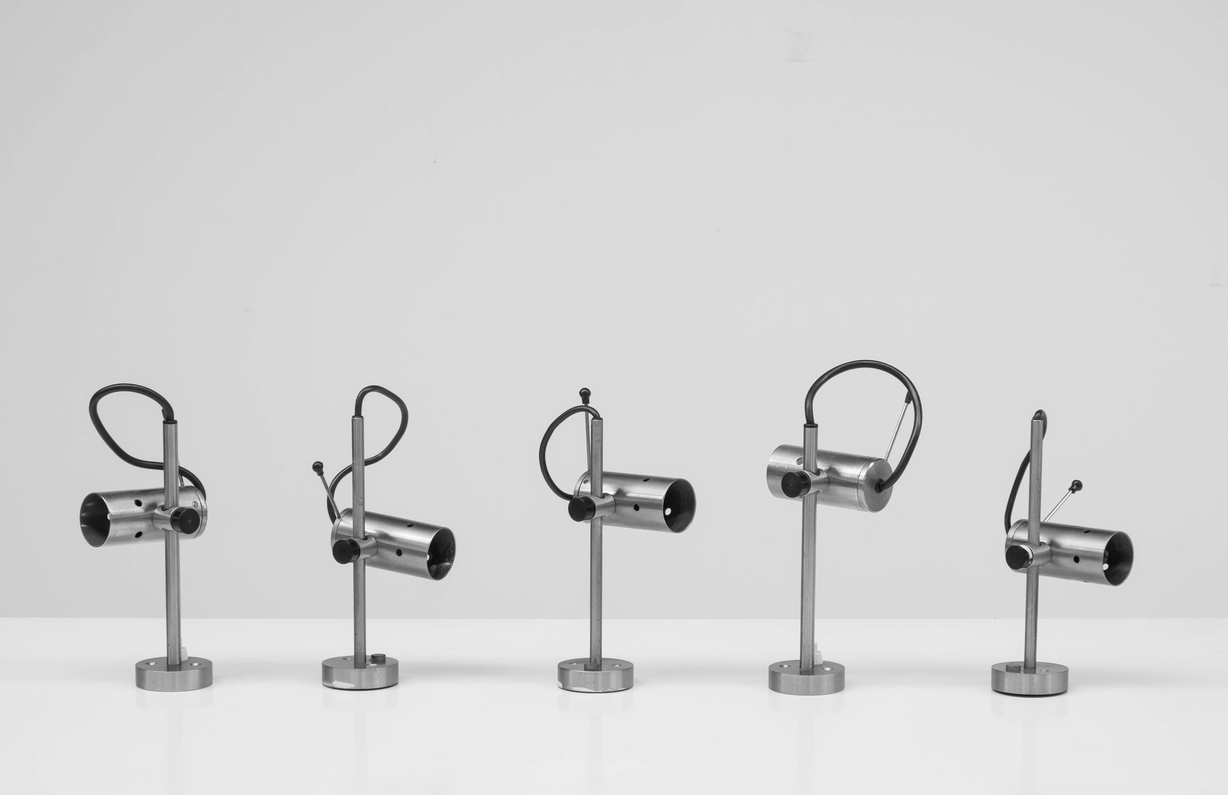 Five appliques by Italian designer Tito Agnoli for O-luce, 1954.
Stainless steel axis with adjustable fitting containing a bajonet socket. 
Two appliques with switch, three without. 

These are no longer published today.