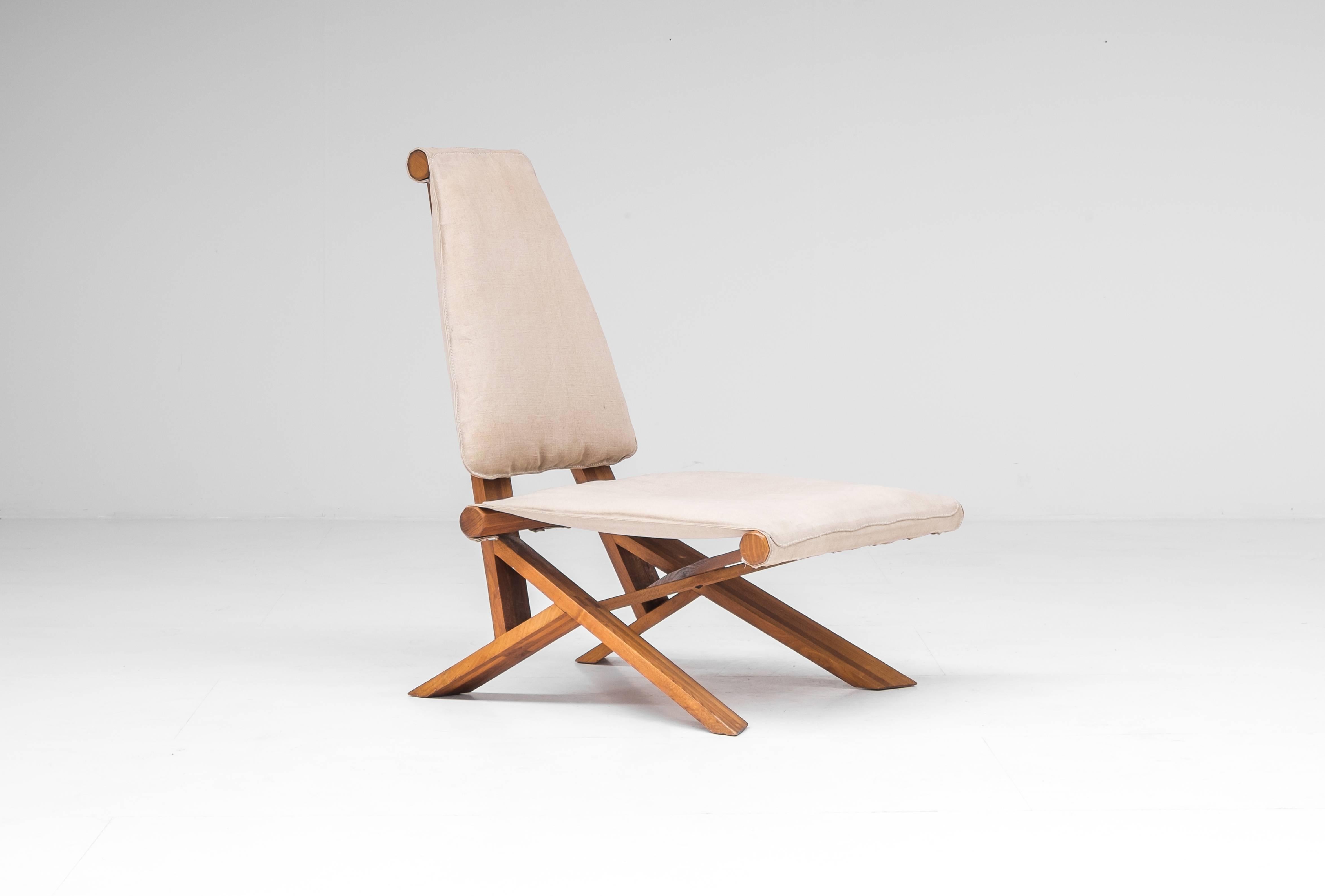 The S46 Dromadaire chair was designed by Pierre Chapo and was produced in France by Ebenisterie Seltz, circa 1980. The frame is made from elm with a canvas upholstery. The weight and shape of the structure of this piece determine its equilibrium and