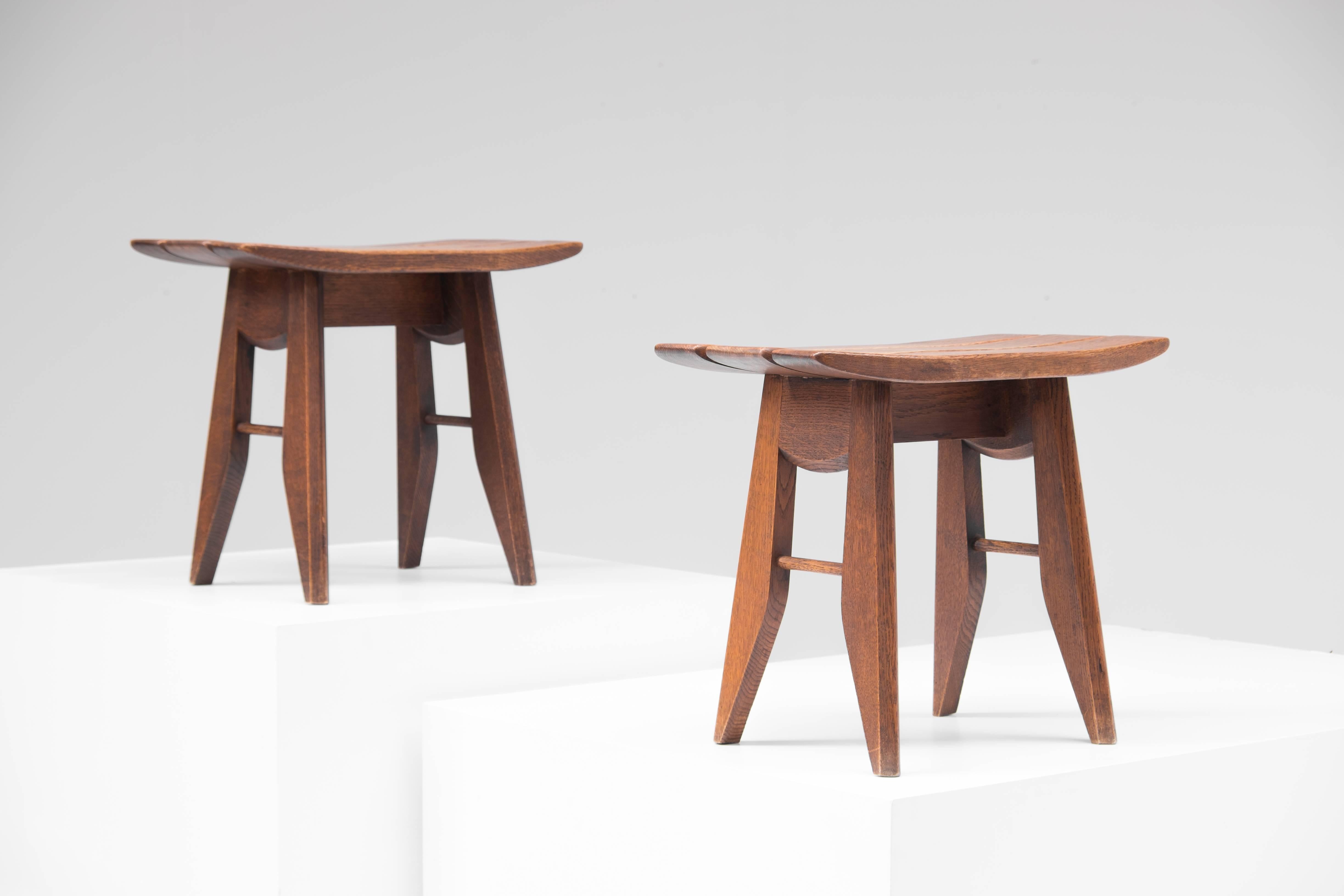 Pair of oak stools with a beautiful overall patina, by Guillerme et Chambron for Votre Maison, produced in France during the 1960s.

These stools have a japonesque inspired shape, strongly resembling the architecture of a Nakayama Torii gate. With