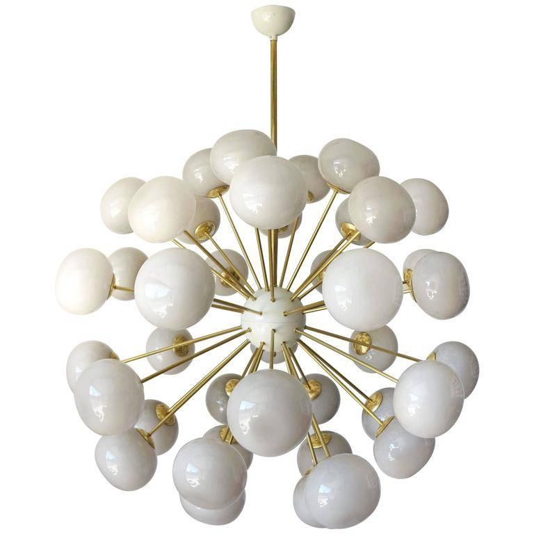 Italian sputnik chandelier with 40 Murano pebble glass shades mounted on brass frame / Designed by Fabio Bergomi for Fabio Ltd / Made in Italy
40 lights / E12 or E14 type / max 40W each
Measures: diameter 49 inches / height 59 inches including rod