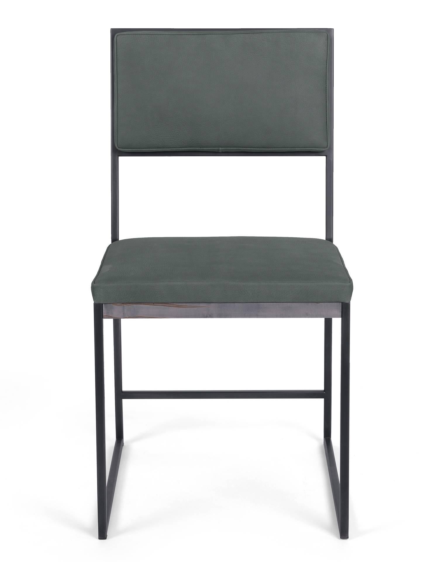 The sleek and modern Hendrick dining chair features clean lines and a luxurious leather upholstered seat and back, adding comfort and sophistication to any room. An oxidized ambrosia maple trim compliments the blackened steel frame. 

COM/COL