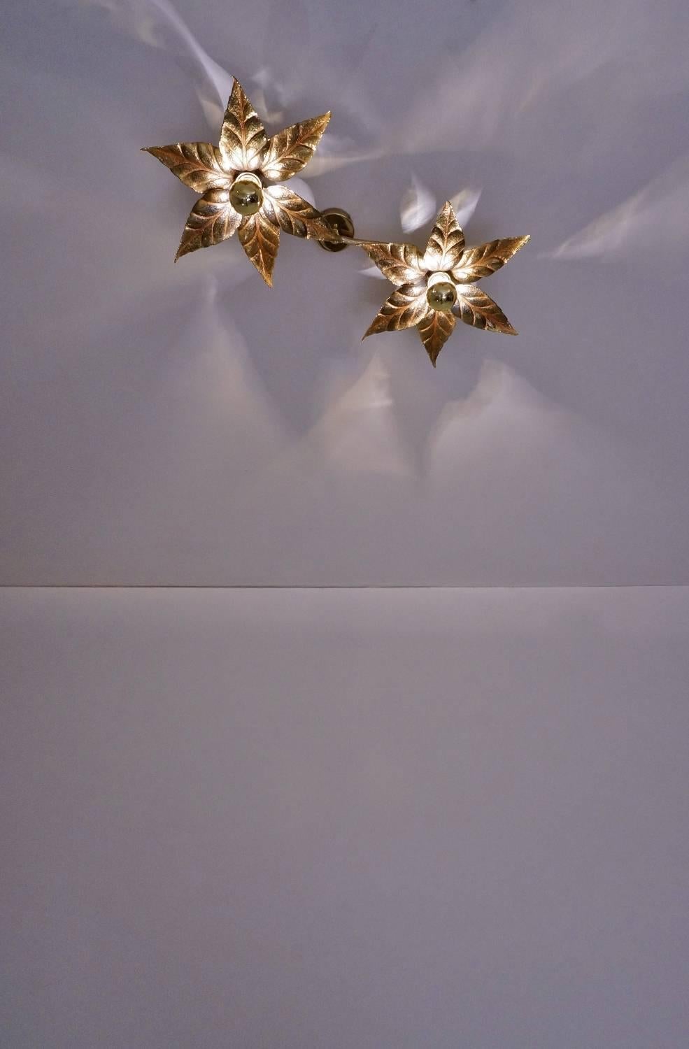 Brass flowers ceiling or wall light in the style of designer Willy Daro manufactured by 'Massive Lighting,' circa 1970s, Belgian.

Thoroughly cleaned respecting the antique patina, newly rewired and earthed, in full working order and ready to use.