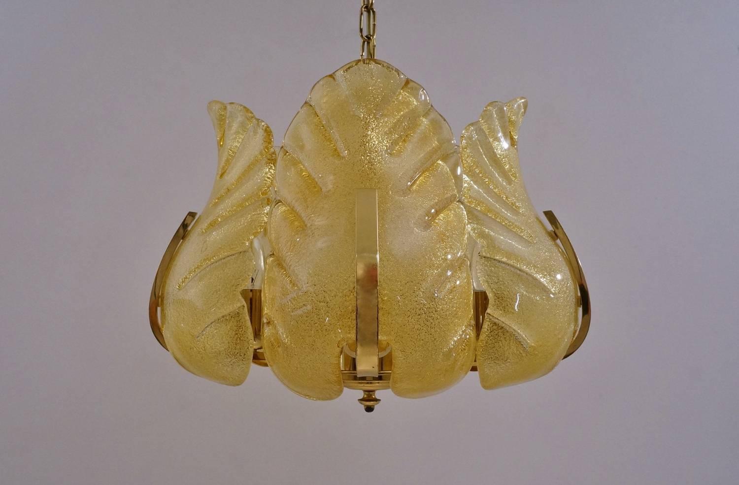 Carl Fagerlund Orrefors chandelier gold glass leaves on a brass frame, five lights, circa 1960s, Sweden.

Thoroughly cleaned respecting the vintage patina; newly rewired, in full working order & ready to install. Light bulbs included.

This
