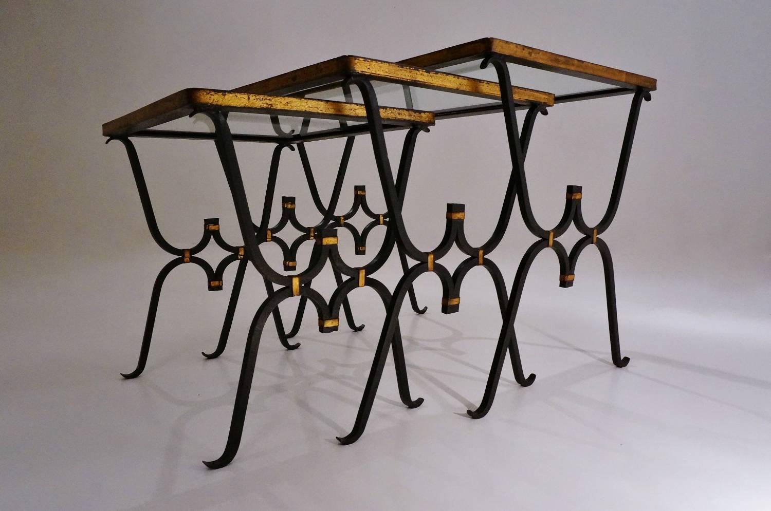 Rene Drouet nesting tables, iron and bronze frames with original glass tops, circa 1950s, French.

These tables have been gently cleaned respecting the vintage patina.

These vintage tables are in the style of Rene Drouet. The hand-forged iron