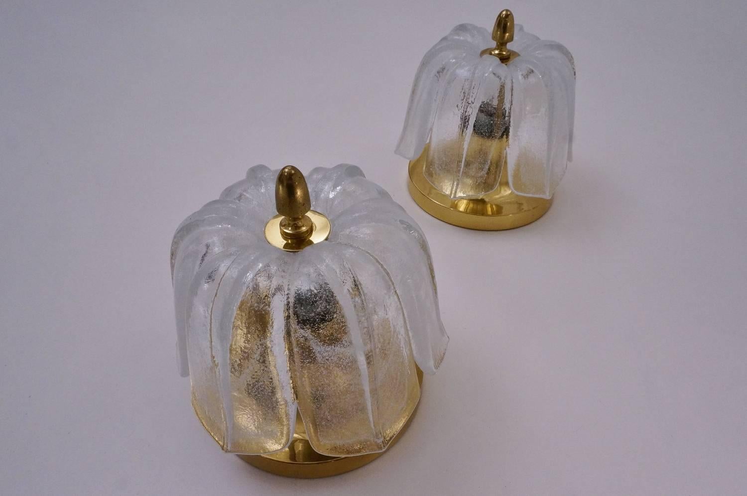 Limburg glass pair of wall lights, tulip shaped shade on a brass base, circa 1970s, German.

Both lights have been thoroughly cleaned respecting the vintage patina; newly rewired & earthed, in full working order & ready to install. Light