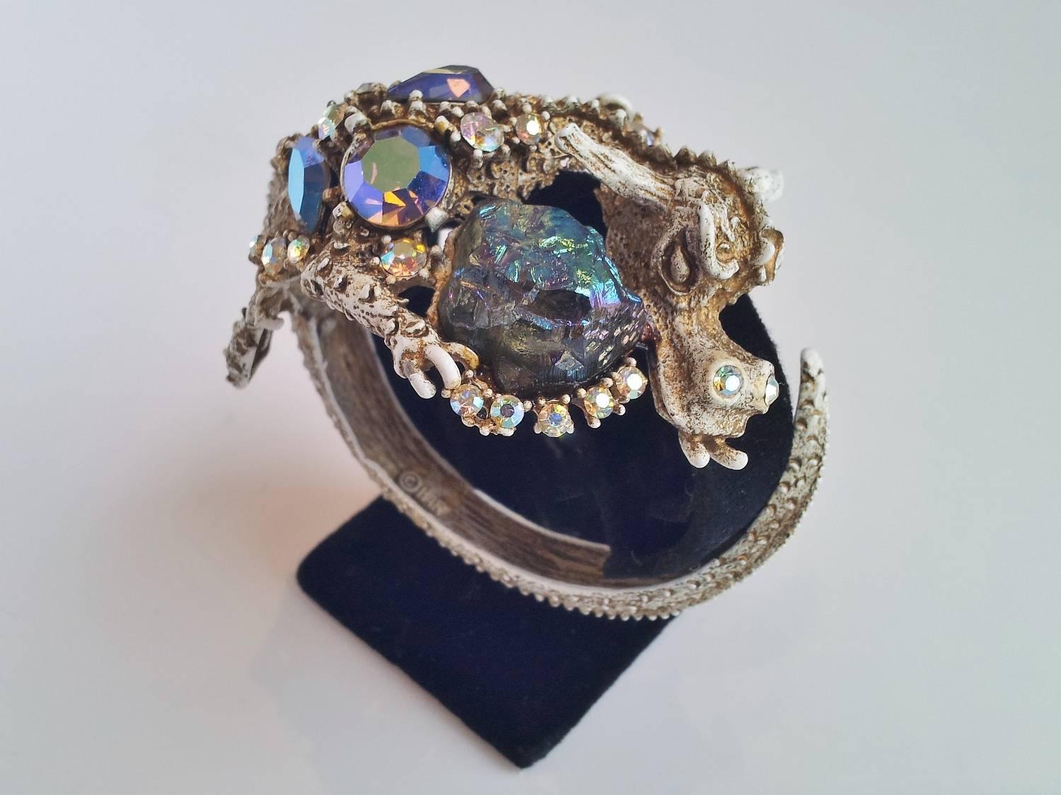 HAR vintage dragon hinged-clamper bangle bracelet and earrings, 1959, New York. The Dragon`s head predominates this bracelet which is encrusted with ‘Aurora borealis’ rhinestones and ‘lava rocks’ in various shapes, sizes and colours of green &