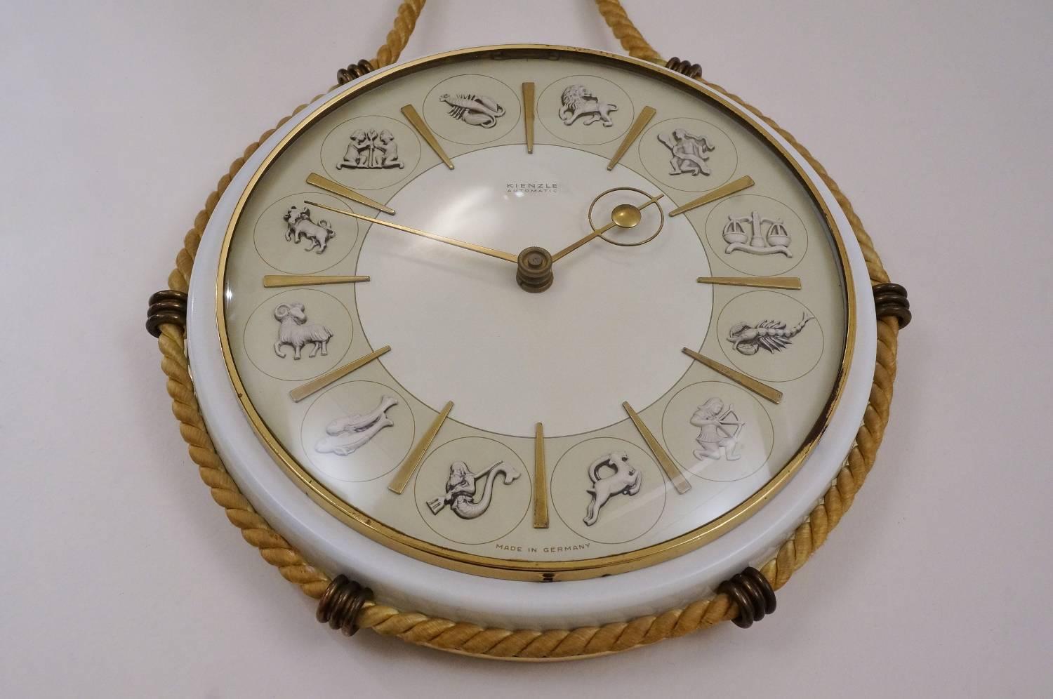 Kienzle clock Zodiac images, circa 1950s, German.

This clock has been gently cleaned while respecting the vintage patina. The clock mechanism is original and working. One D-sized battery is included.

Henry Johannes Möller 1950s design is a