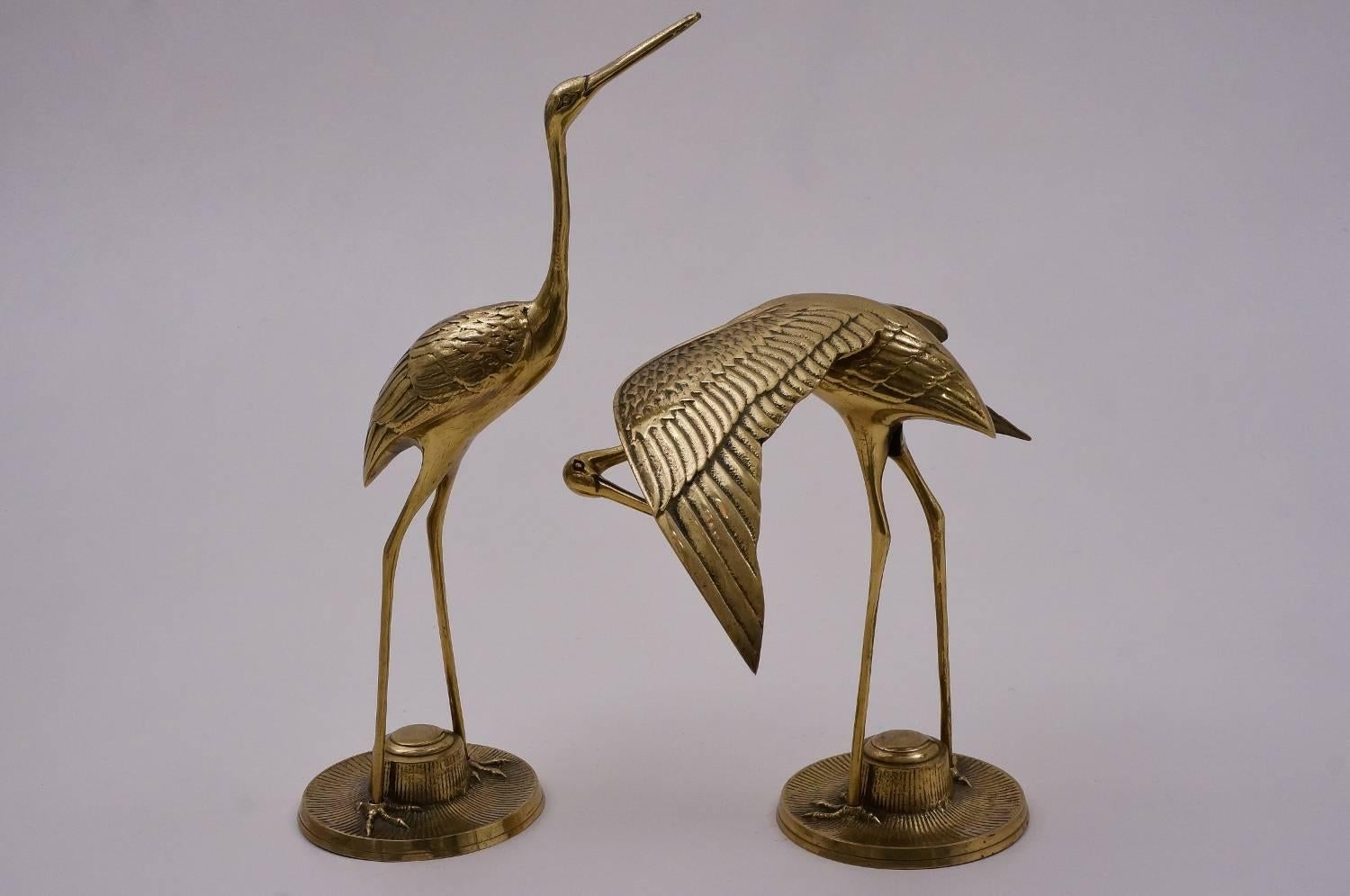 Pair of brass bird sculptures, herons, circa 1960s, French.

This pair of vintage sculptures have been gently cleaned while respecting the aged patina. 

Perfect to finish a Hollywood Regency interior this pair of solid brass herons are