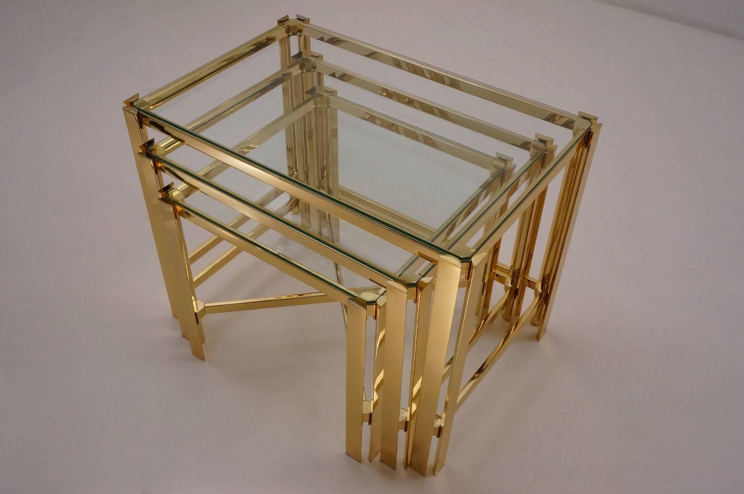 Gold nesting tables, gold-plated gilt frames with glass tops by Pierre Vandel, circa 1970, French.

This set of tables have been gently cleaned respecting the vintage patina and they are ready to use.

With their geometric sculptural forms this