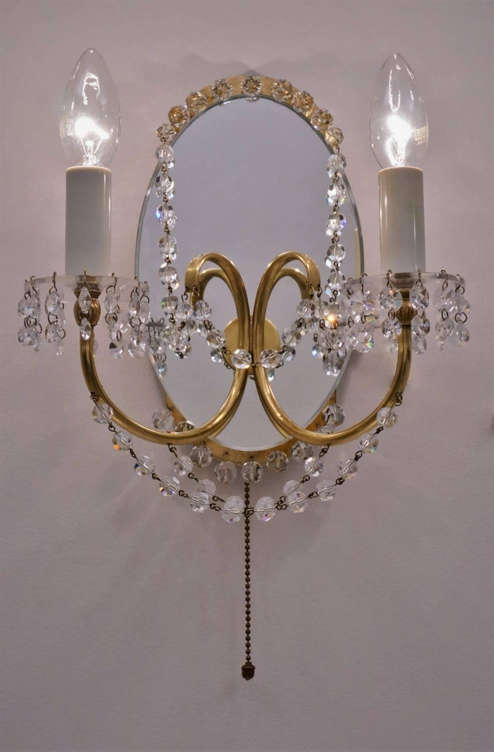 Maison Jansen sconces crystal beads, brass arms, Lucite bobeches with mirror back, French, circa 1940s.

Both lights have been thoroughly cleaned respecting the vintage patina. Newly rewired, earthed, in full working order and ready to install.