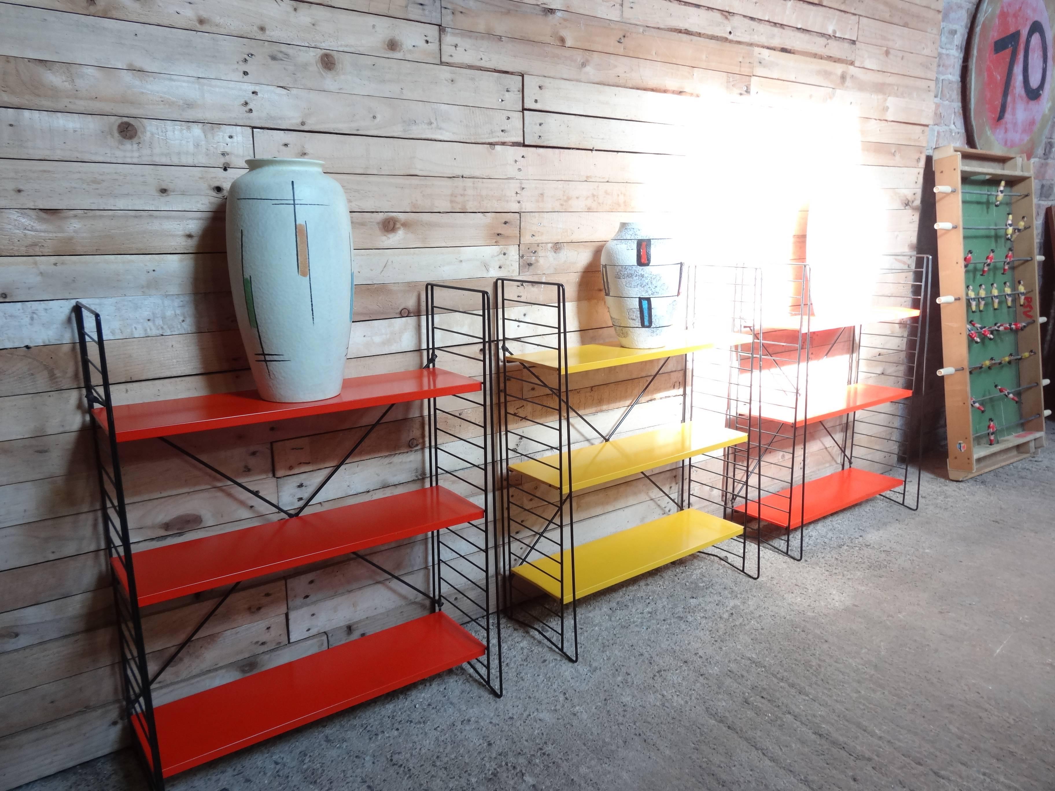 Sought after freestanding three Tomado rack (two orange/red and one yellow) in good vintage condition, price is per rack. A real rarity and very collectable. 

Measures: Height 85cm, depth 29cm, width 65cm, each.

 