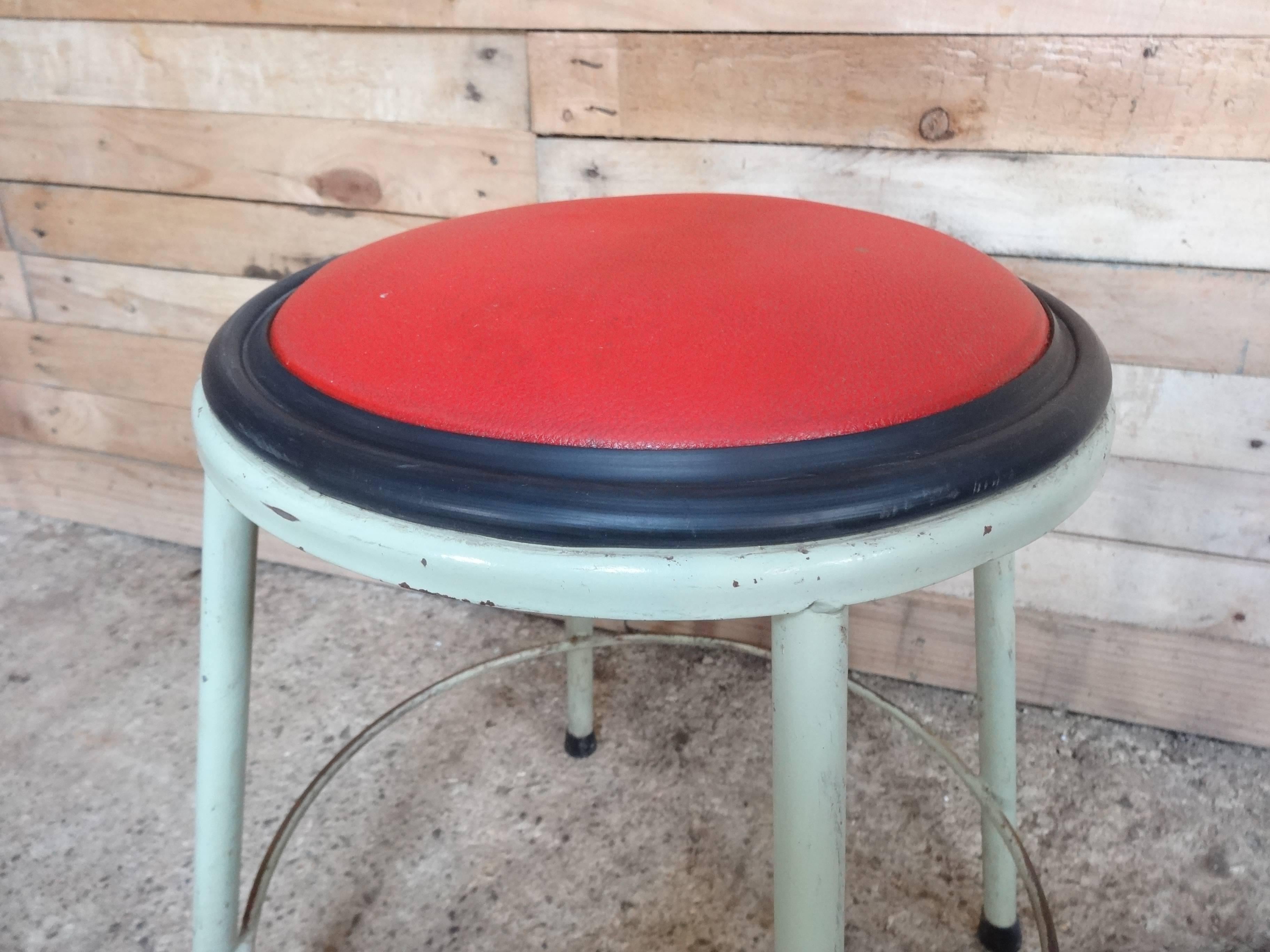 1950s retro vintage French Industrial metal stool with red vinyl seat.