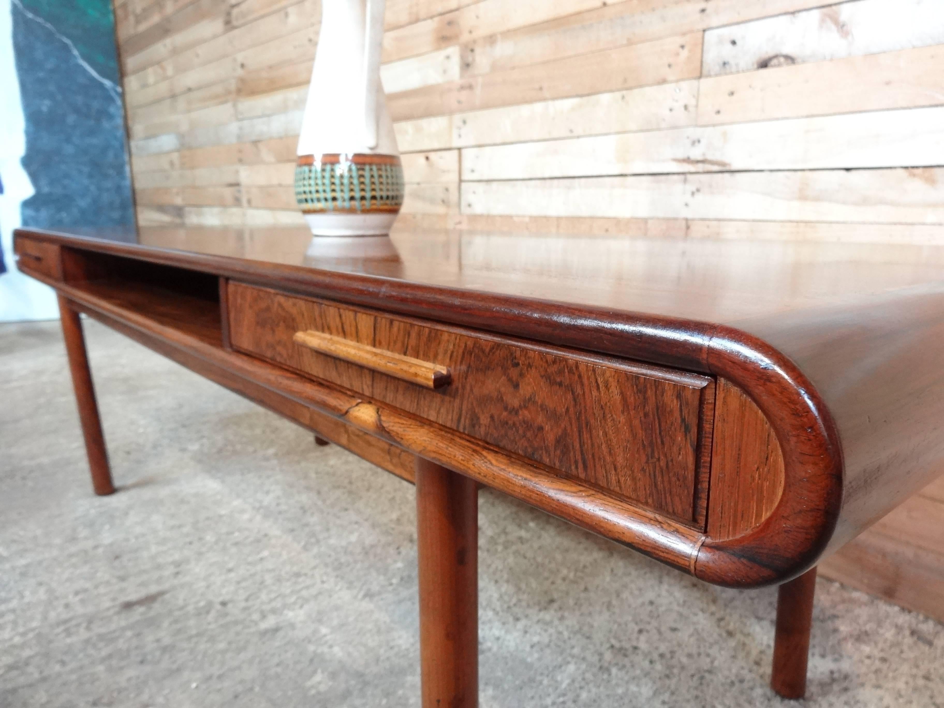Exquisite Danish 1960s retro rosewood coffee table with two drawers.

I have researched this particular table for the last couple of weeks and have not found another table like it on the internet or in any trade / designer books.

Probably one