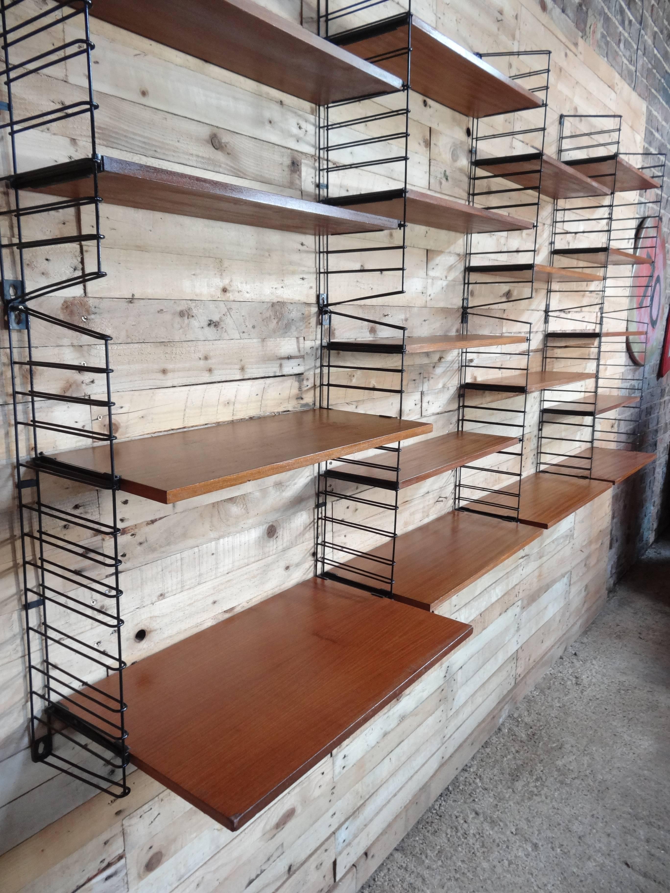 Stunning sought after extra large Tomado rack in very good vintage condition, you will not find another one for sale like this one! Designed by D Dekker for Tomado. The rack comes with ten ladders and 17 teak shelves (four wide ones) and a desk