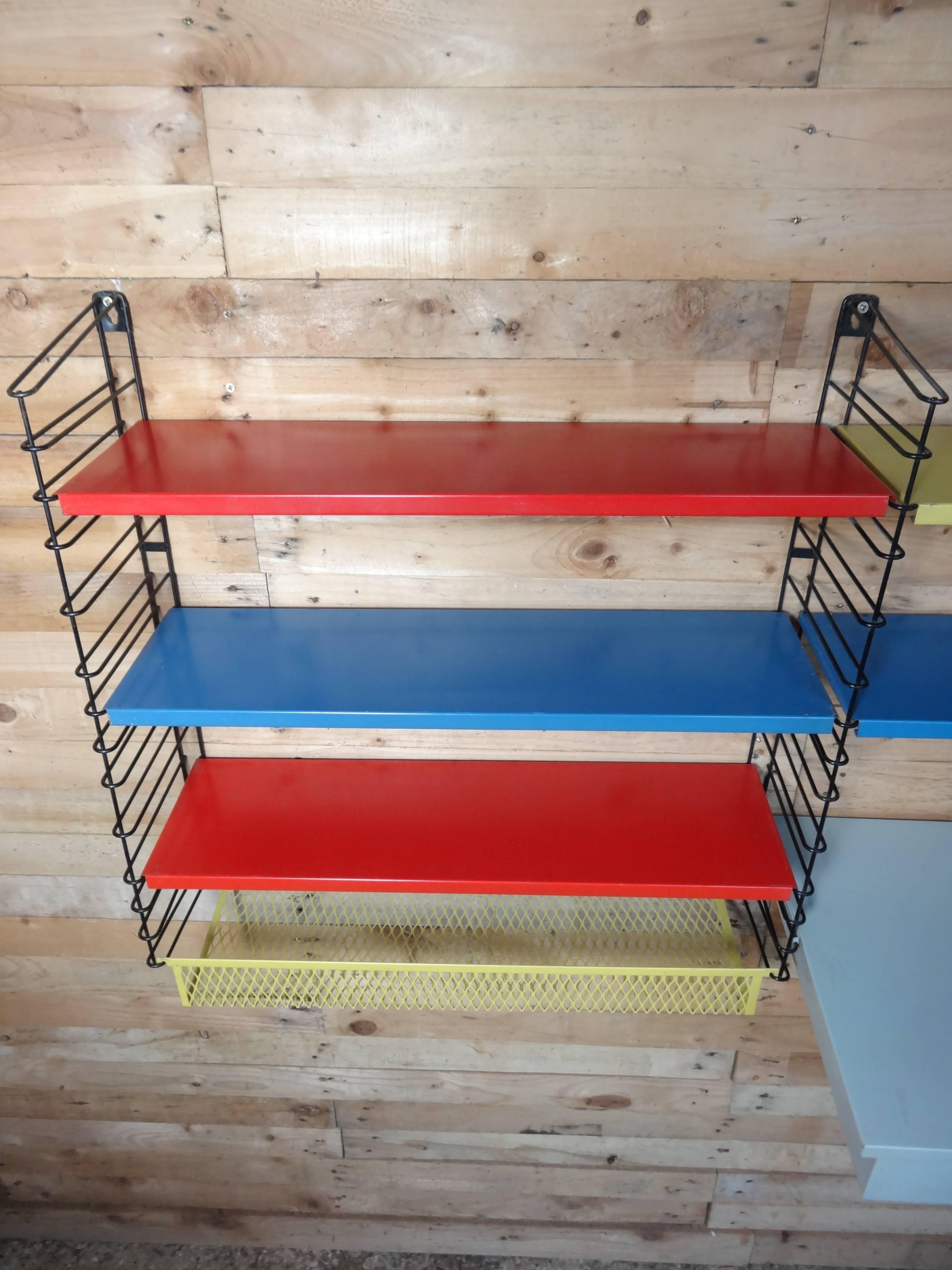 60 retro stunning coloured large metal tomado rack, it has a desk, light and yellow magazine shelf!

This outstanding shelving has typical Tomado design, it comes with five shelves and a sought after desk, original light (impossible to get!) and a