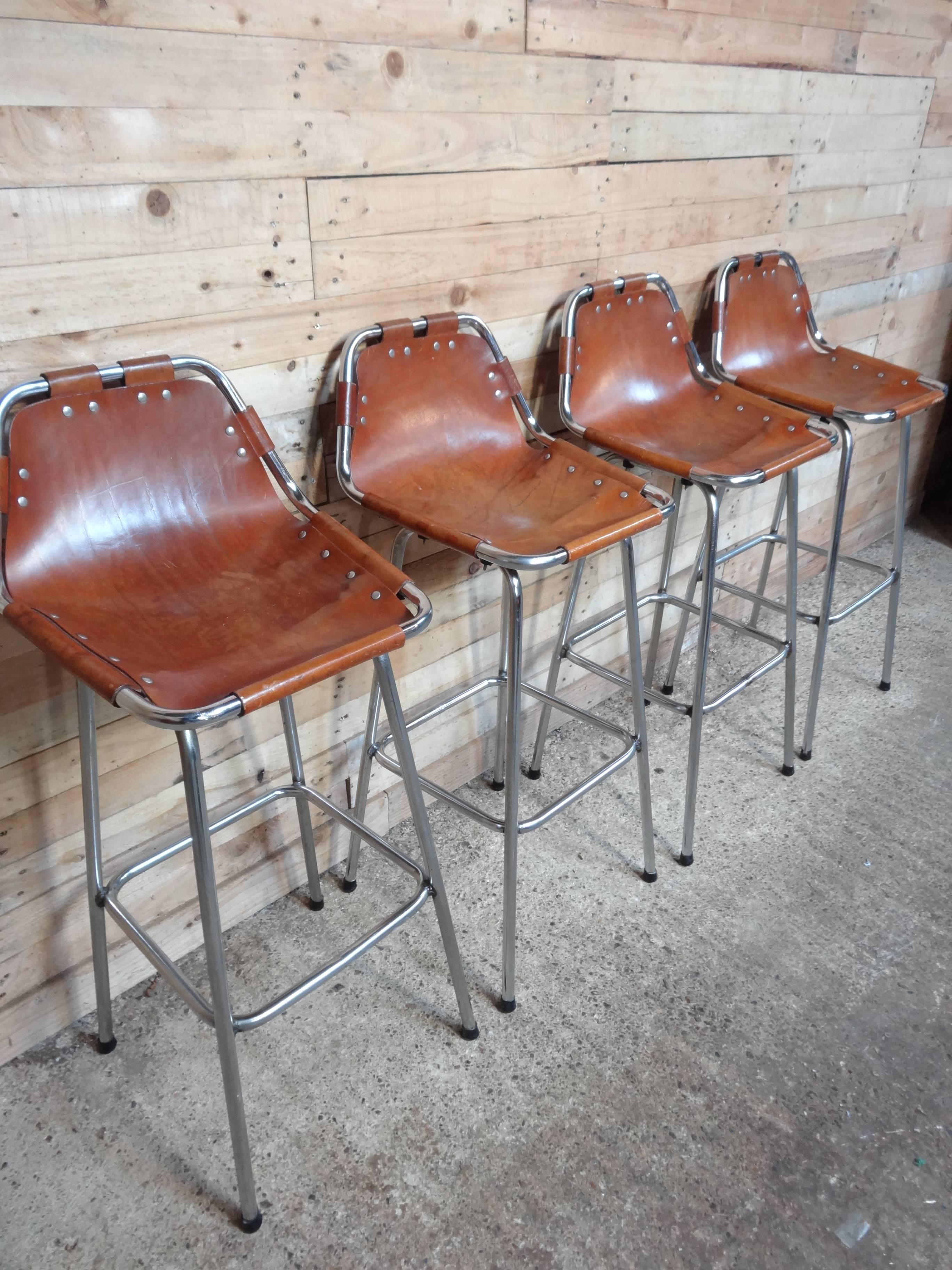 Stunning set of four stools, designer Charlotte Perriand used these in the Ski Resort Les Arcs, circa 1960. These stools were commissioned to be made by Cassina, one of the best Italian furniture maker’s very nice chrome tubular frame with thick