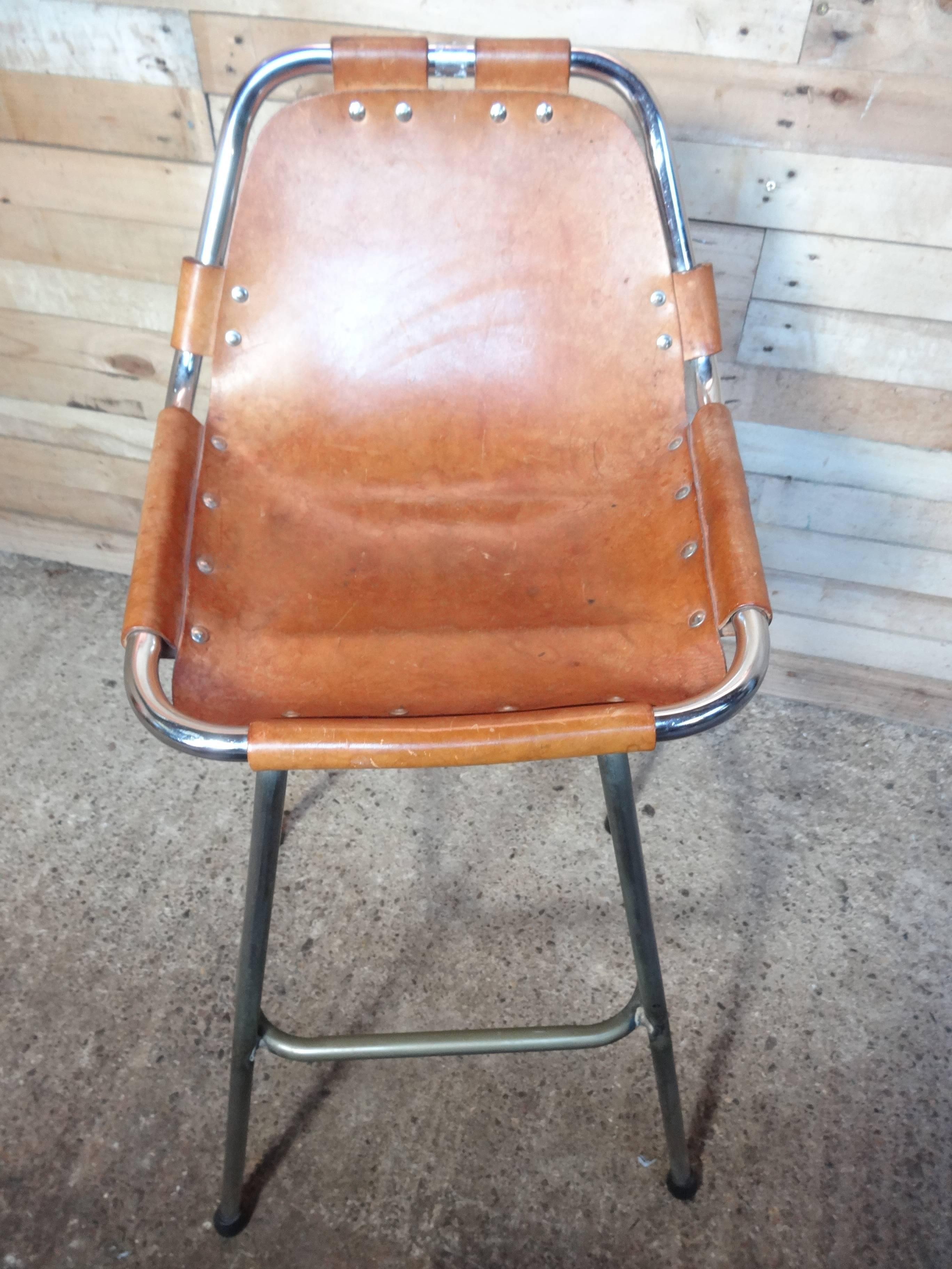 Stunning stool, designer Charlotte Perriand used these in the Ski Resort Les Arcs, circa 1960. This stool was commissioned to be made by Cassina, one of the best Italian furniture maker’s very nice chrome tubular frame with thick leather seats,